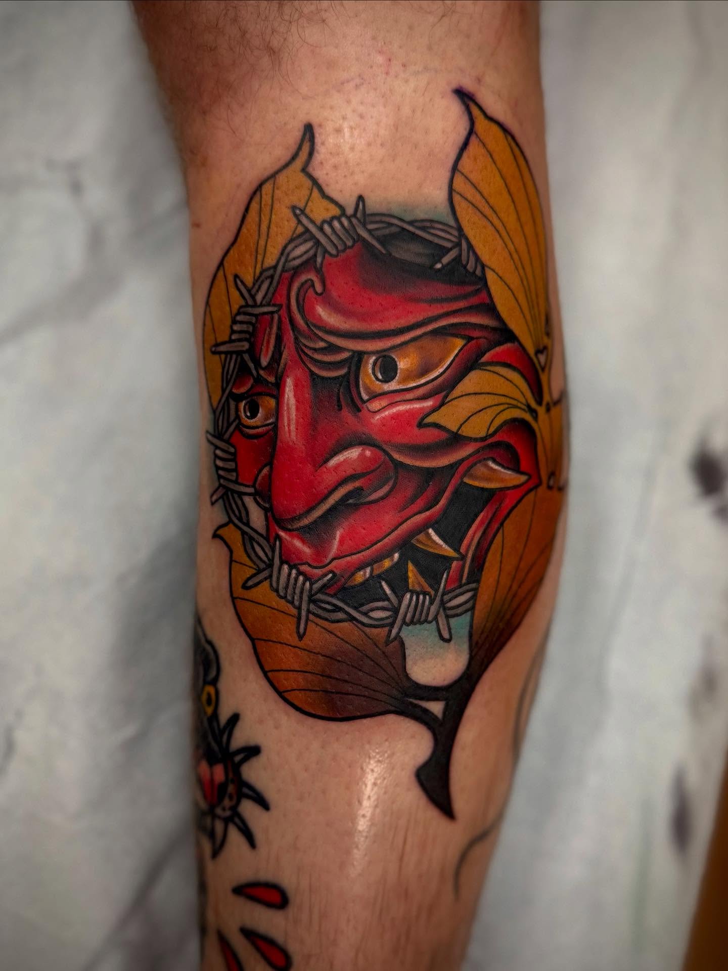 Demon mask American traditional tattoo on the forearm by Sam Babcock