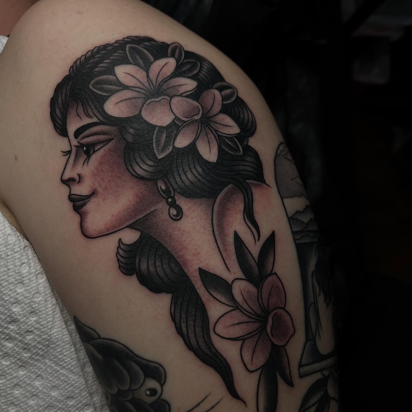Woman with flowers American traditional tattoo on the shoulder by Kayla Faircloth, Charlotte, North Carolina