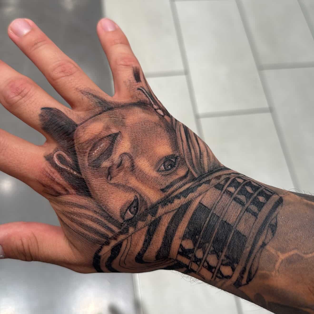 Portrait realism tattoo on the hand by Tattoo Artist