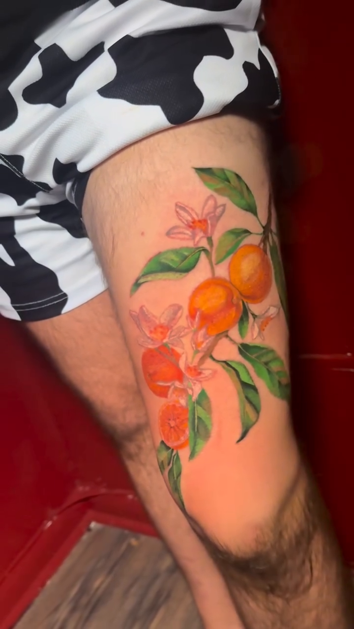 Orange branch with fruit and flowers neo-traditional tattoo on the forearm by Jennifer Ramirez