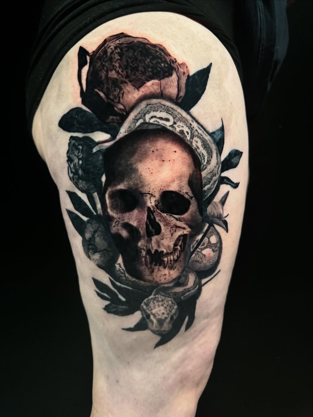 Skull, snake, and rose realism tattoo on the forearm by Brandiane Wells