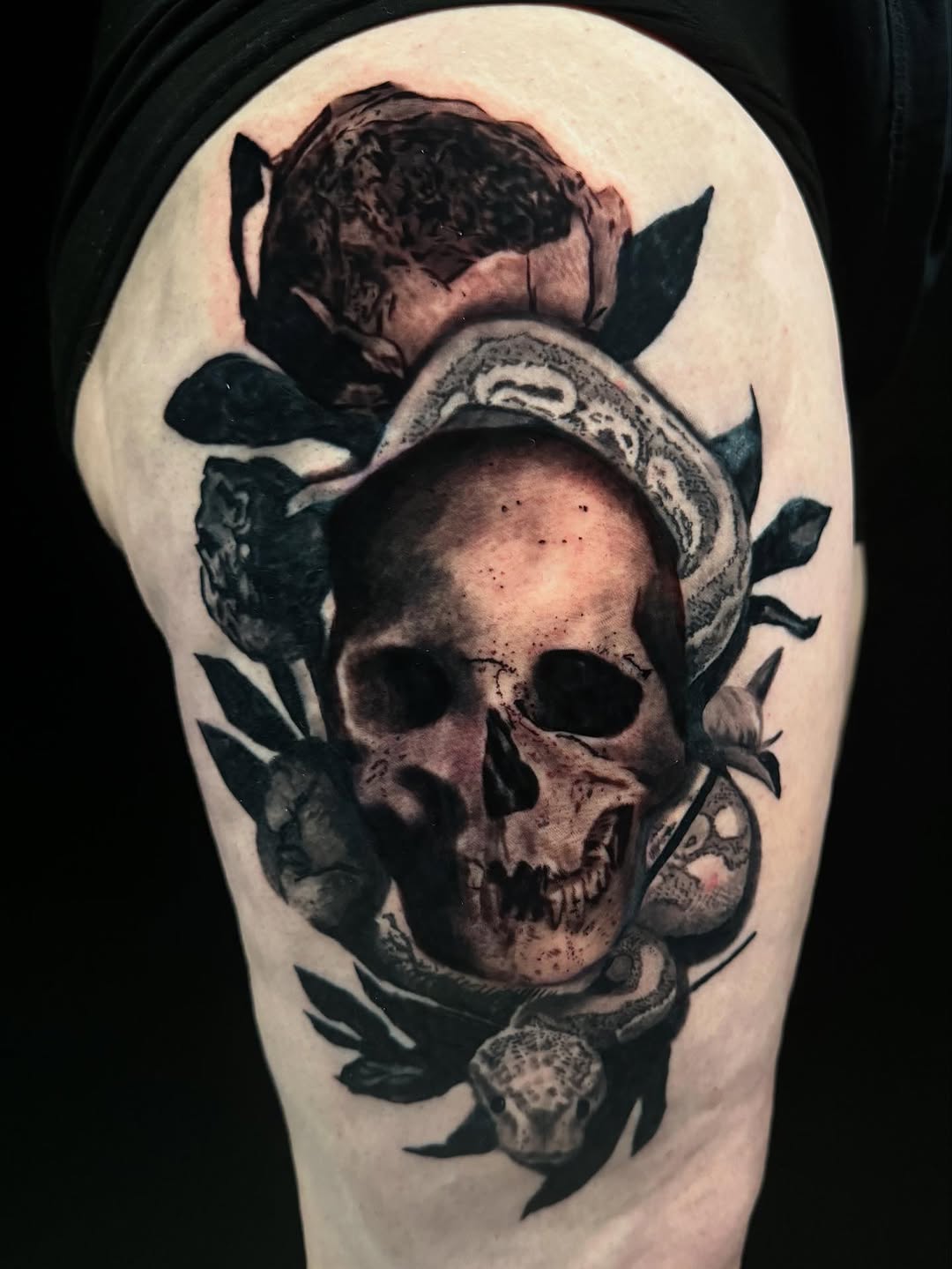 Skull and snake with rose realism tattoo on the forearm by Brandiane Wells
