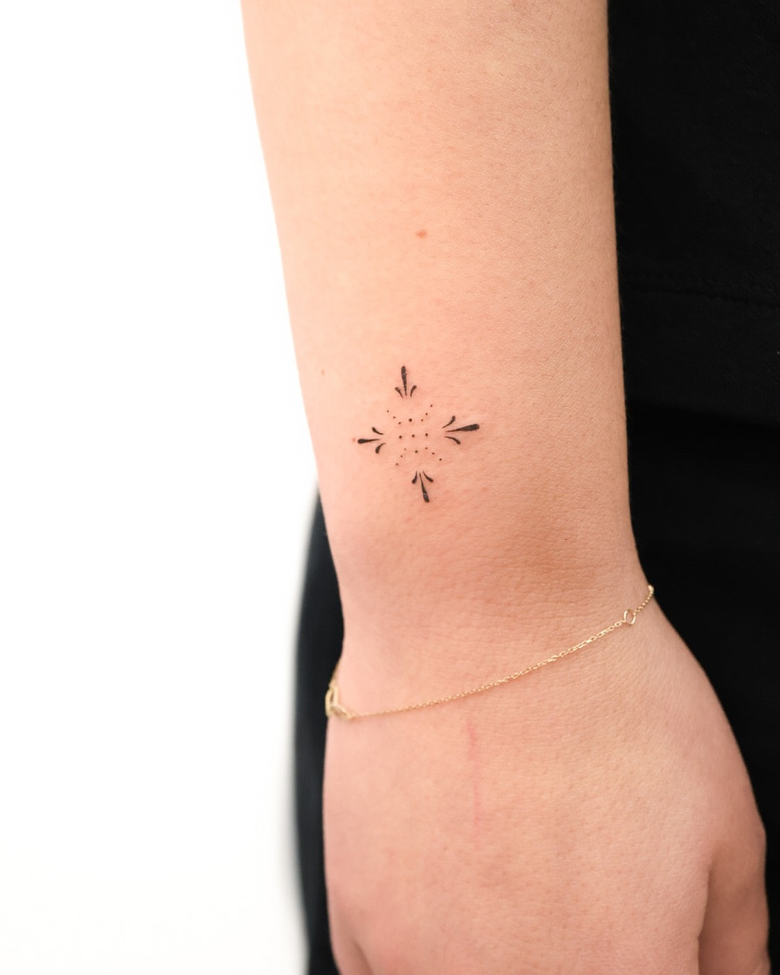 Cross dotwork tattoo on the forearm by Fine Line, New York, New York