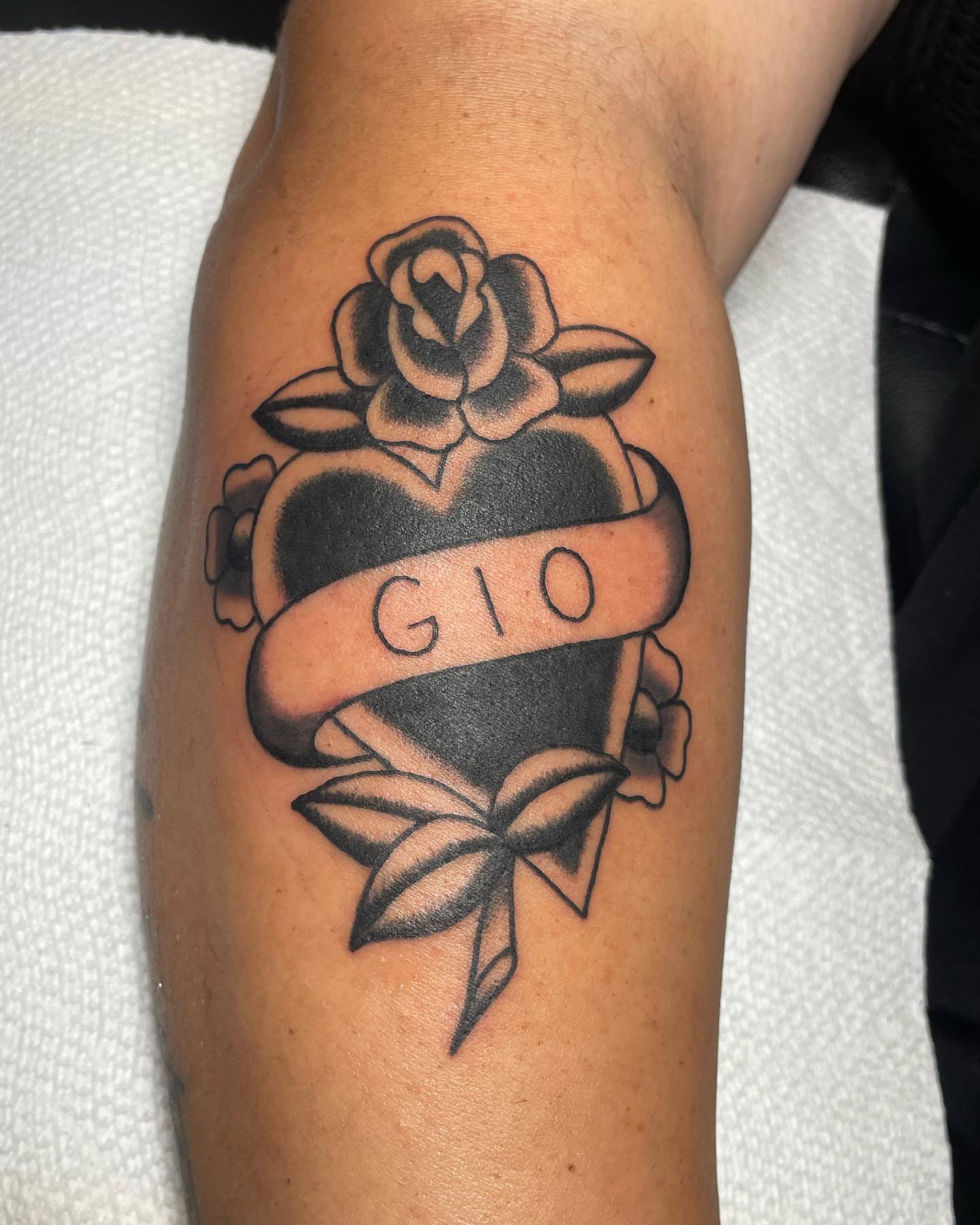 Heart with ribbon American traditional tattoo on the forearm by nancy❣️