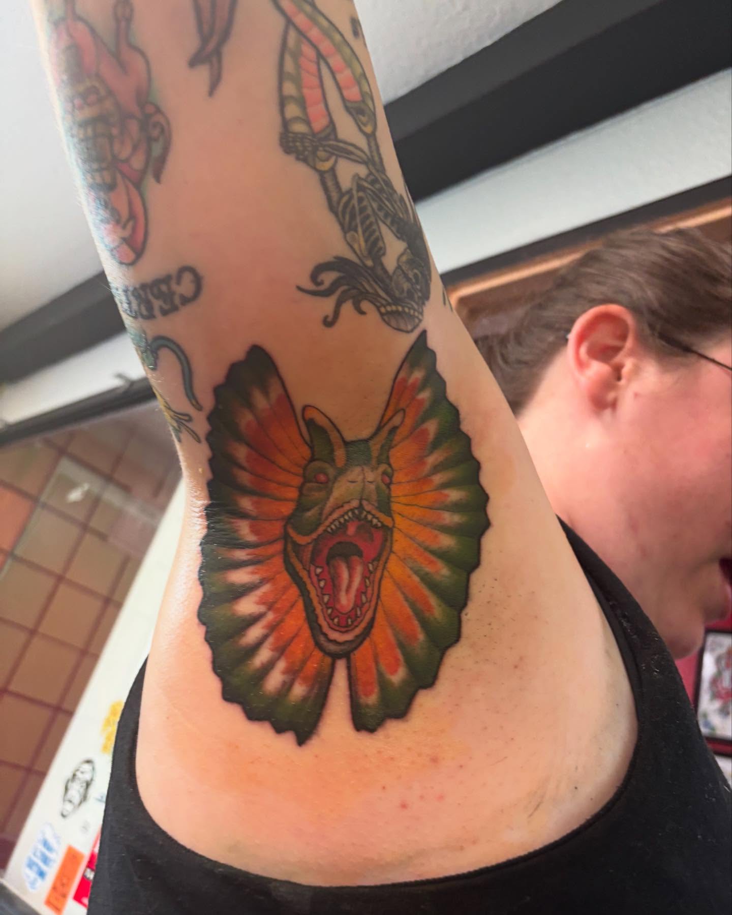 Dinosaur American traditional tattoo on the back by Brandon Seven