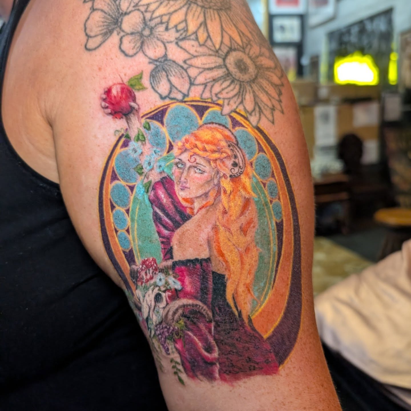 Woman with flowers new school tattoo on the upper arm by Cat