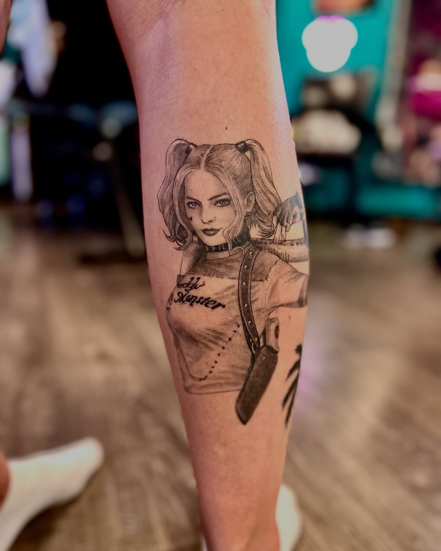 Harley Quinn black and grey tattoo on the forearm by Mallory