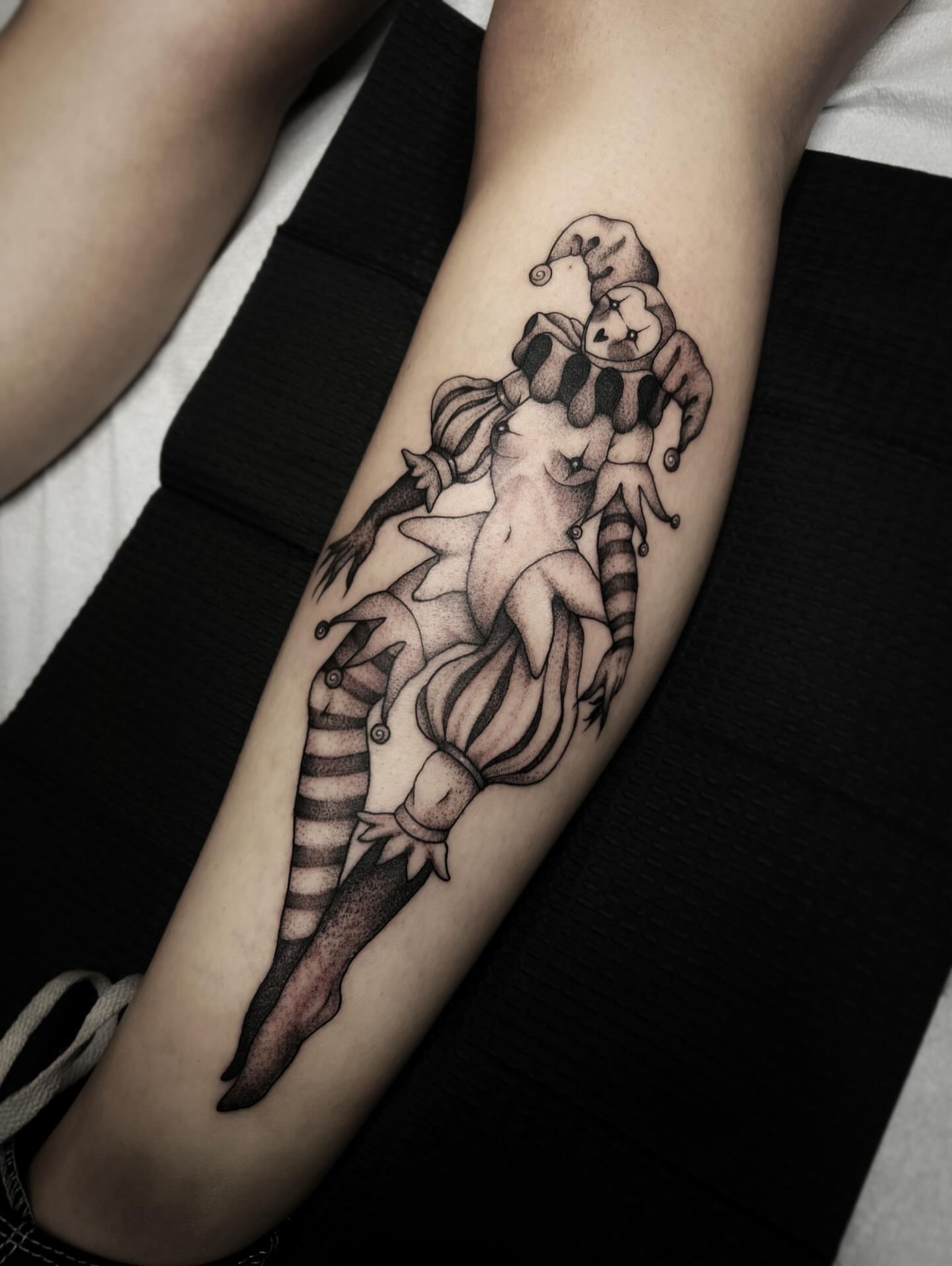 Jester and acrobat black and grey tattoo on the forearm by 𝖎 𝖆𝖒 𝖗𝖔𝖙𝖙𝖎𝖓𝖌 𝖜𝖎𝖙𝖍 𝖞𝖔𝖚