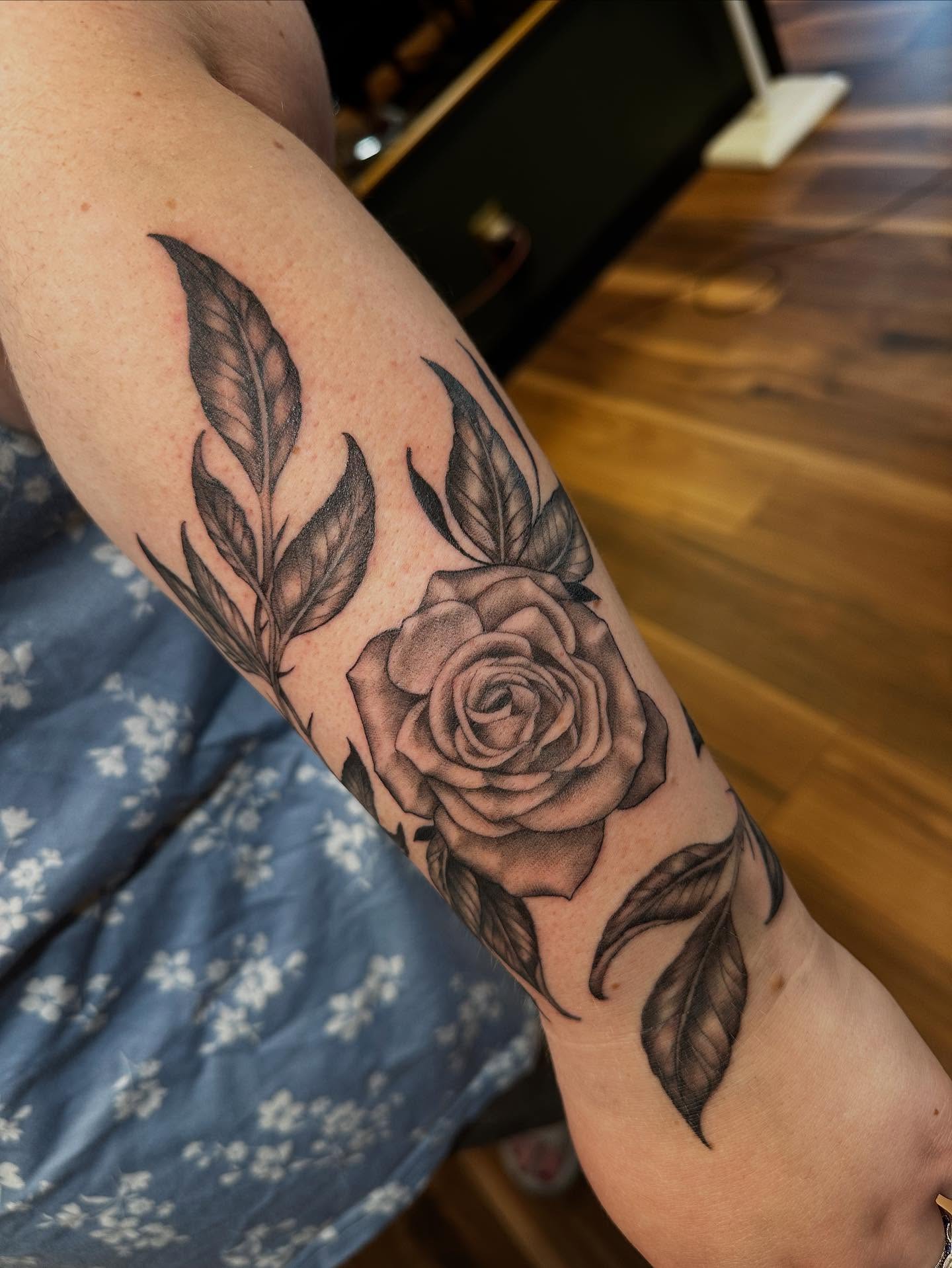 Rose black and grey tattoo on the forearm by Michele Estes