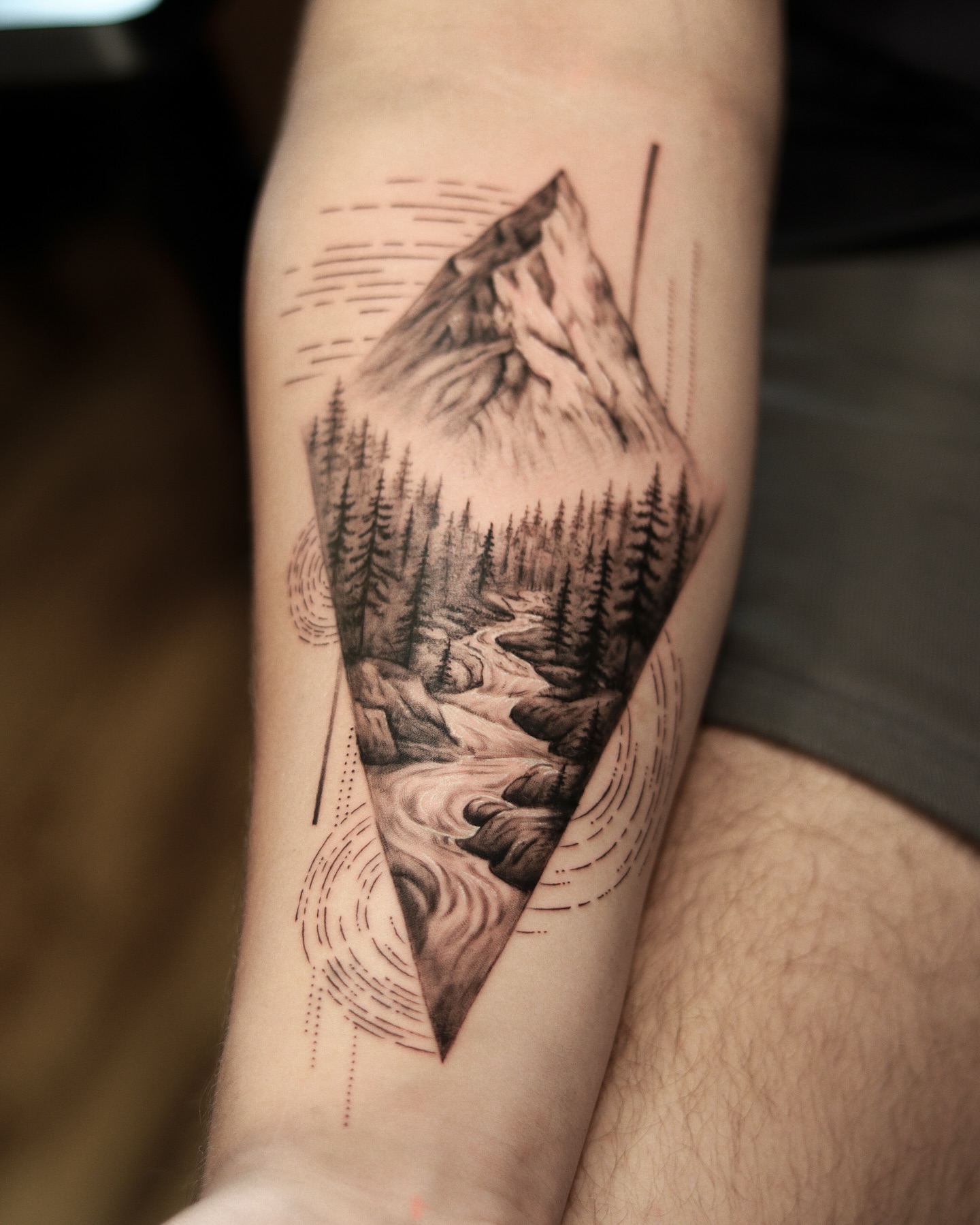 Mountain landscape realism tattoo on the forearm by Arthur Kossoski