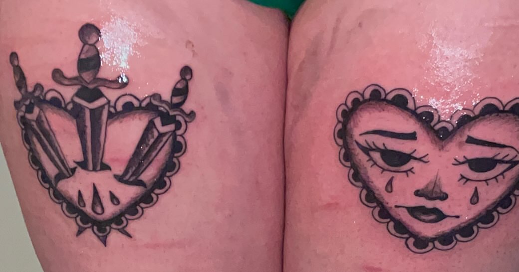 Heart with crying face American traditional tattoo on the thigh by ART