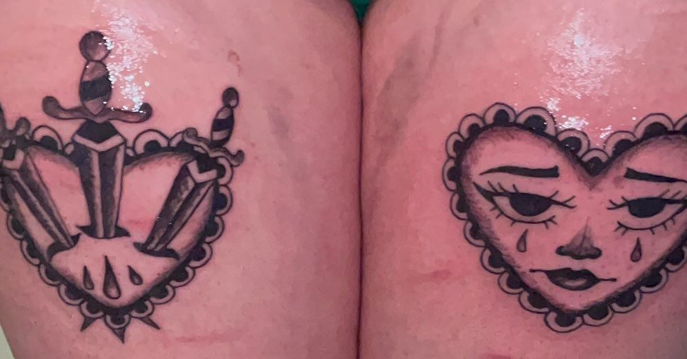 Heart with crying face American traditional tattoo on the thigh by ART