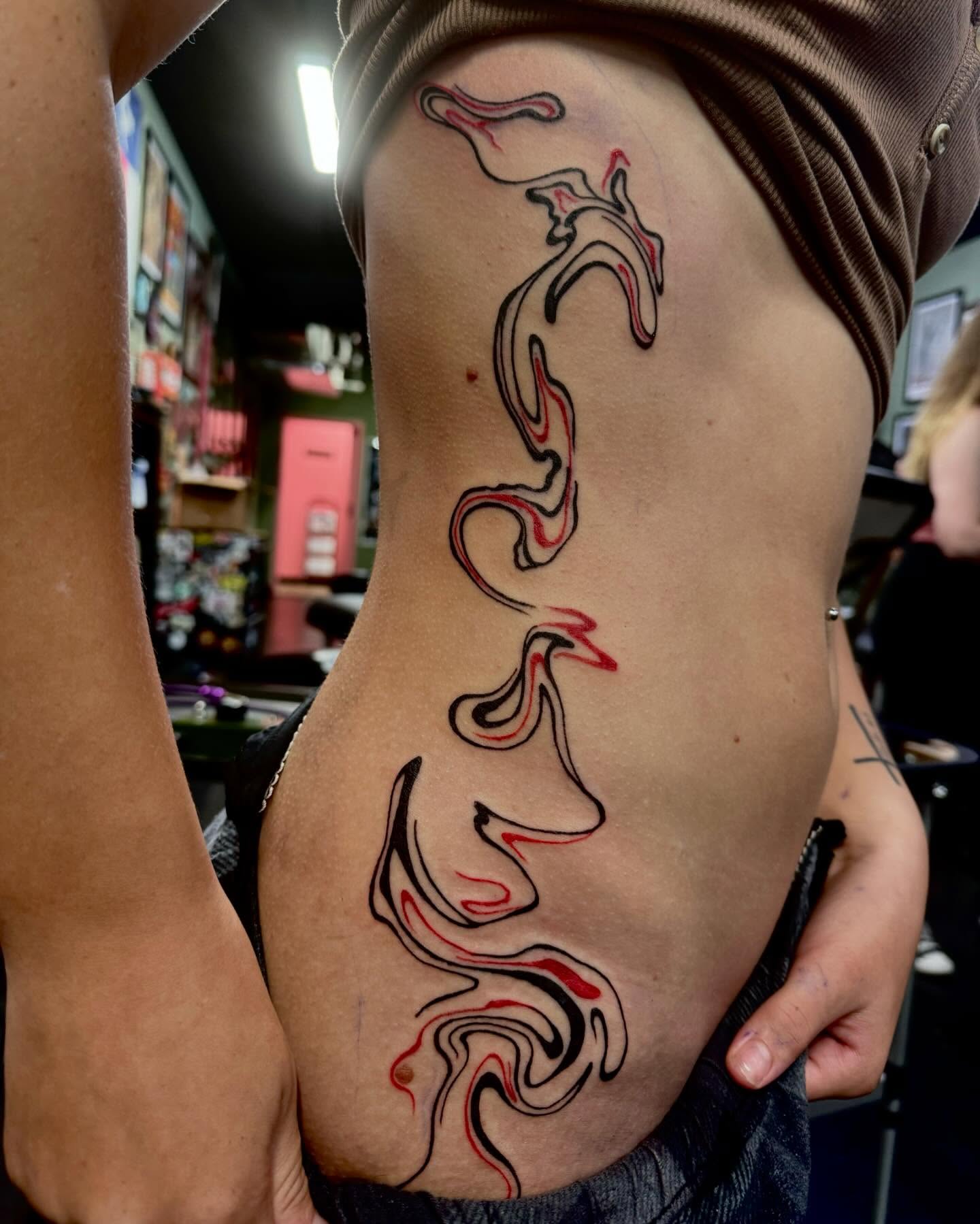 Flame tribal tattoo on the ribs by Kenzie🖤