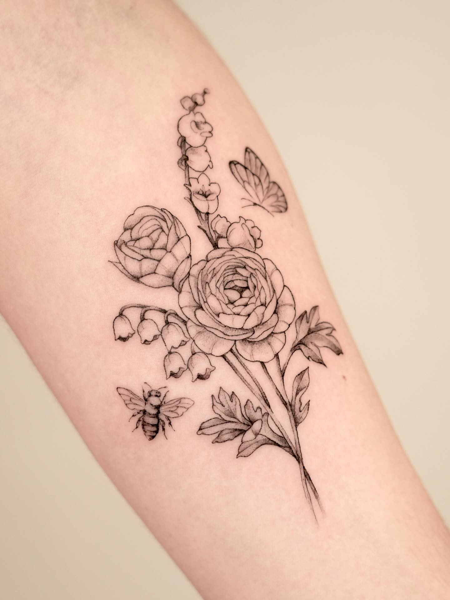 Floral bouquet realism tattoo on the forearm by Marianna D D King