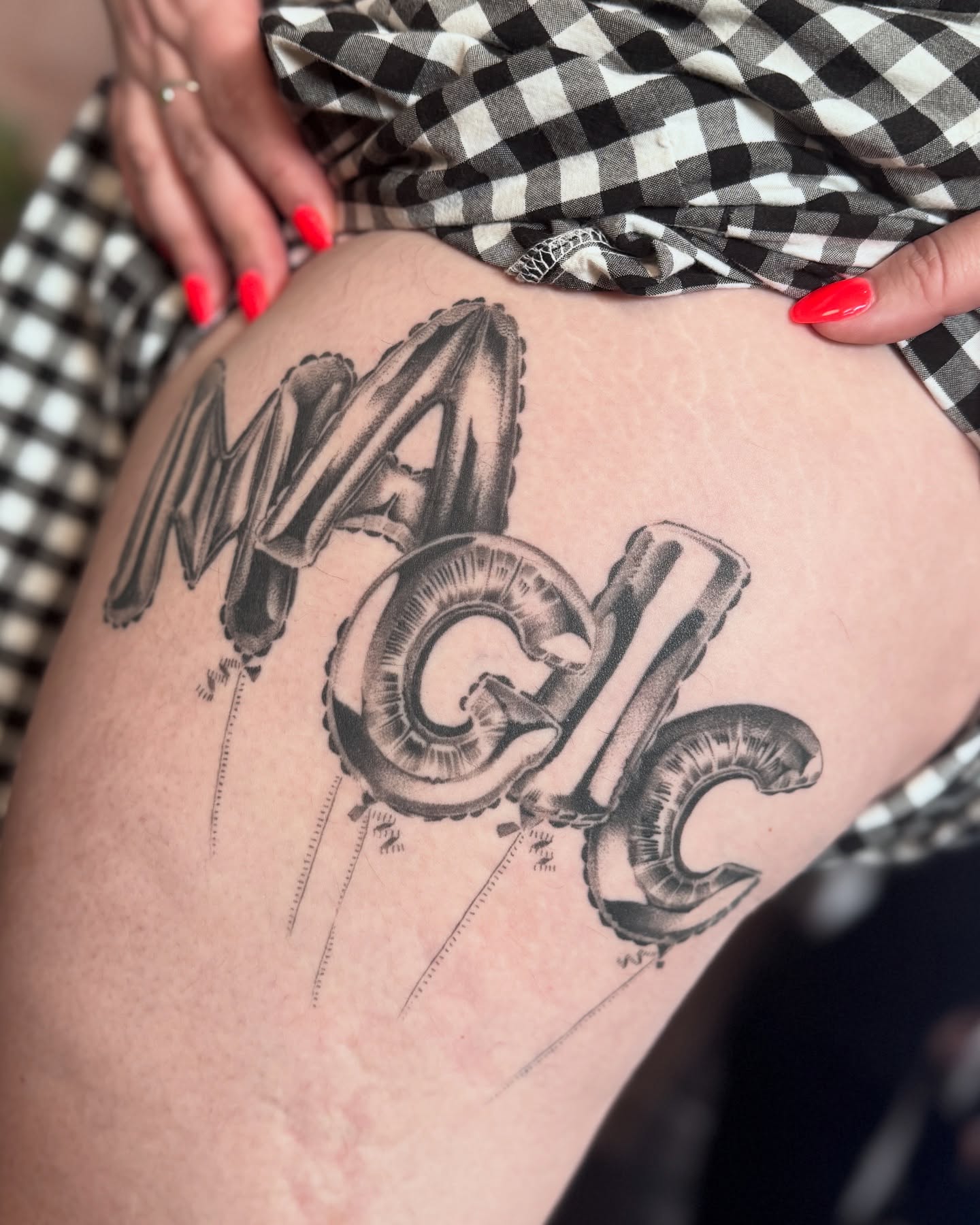 Balloon letters lettering script tattoo on the thigh by Jenni Palomaa