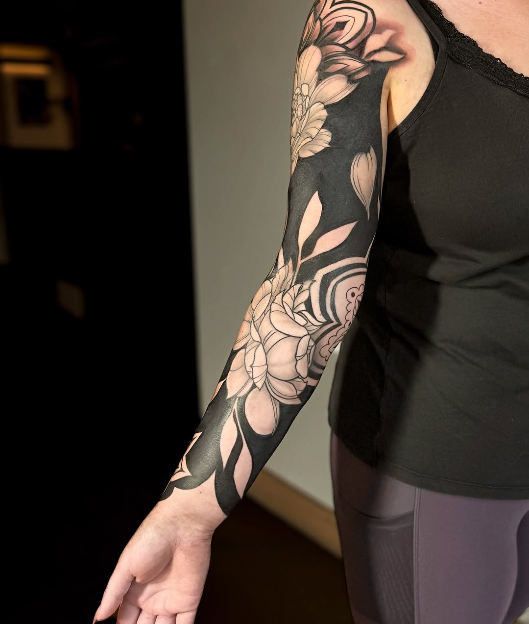 Floral sleeve with black background Japanese tattoo on the upper arm by Jewels, St. George, Utah