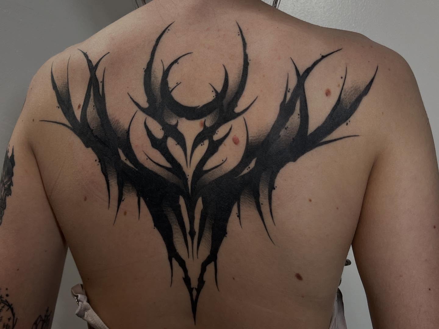 Antlers tribal tattoo on the back by Ty’s Tattoos