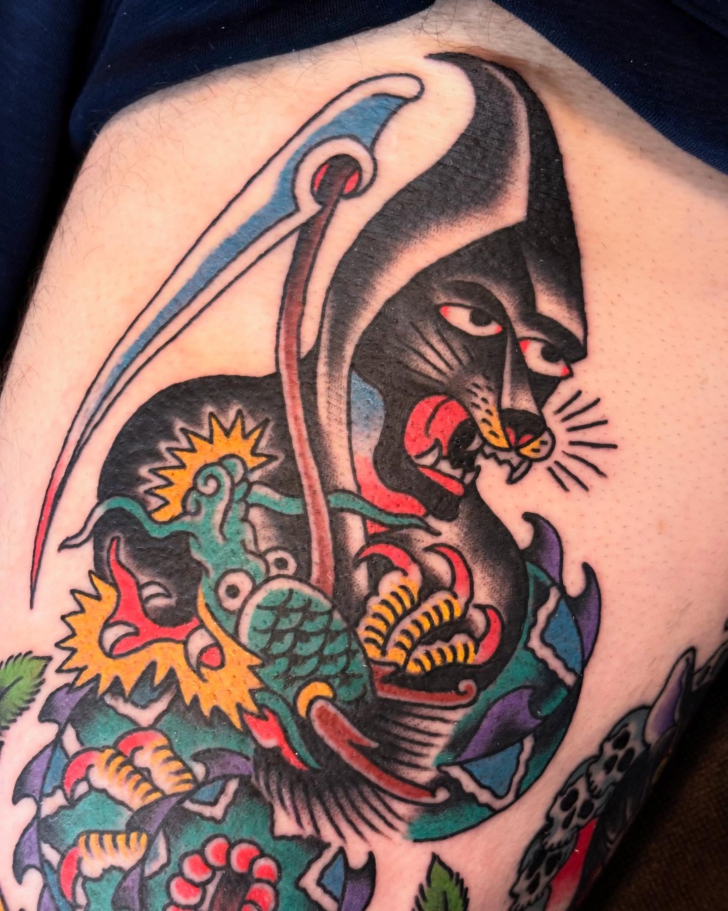 Cat and dragon American traditional tattoo on the thigh by Nick Rodin