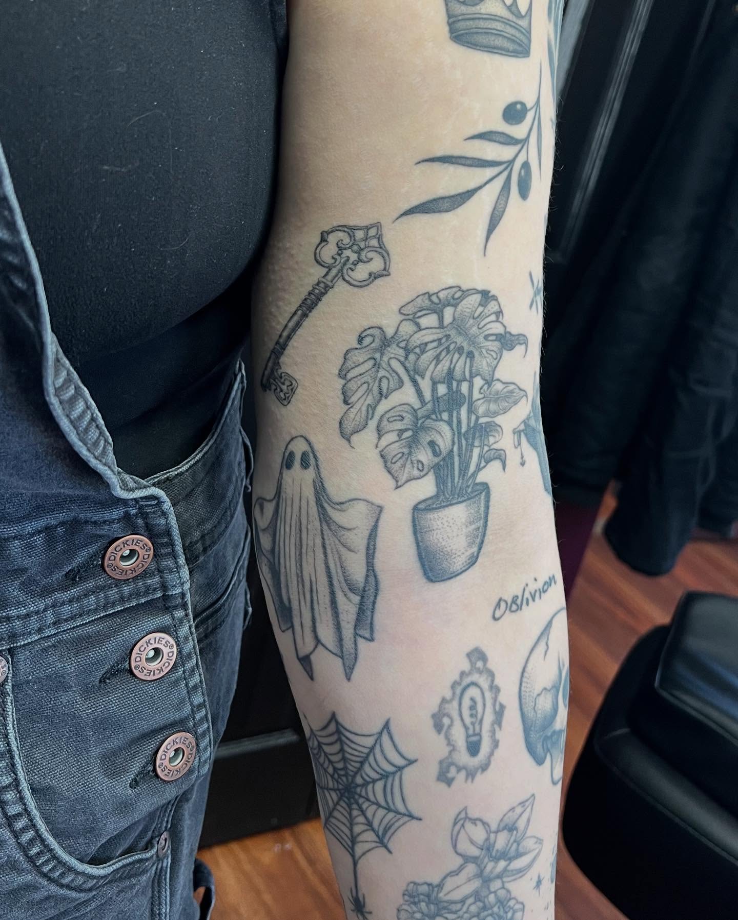 Ghost and plant black and grey tattoo on the forearm by Kelli Donegan ๐ท