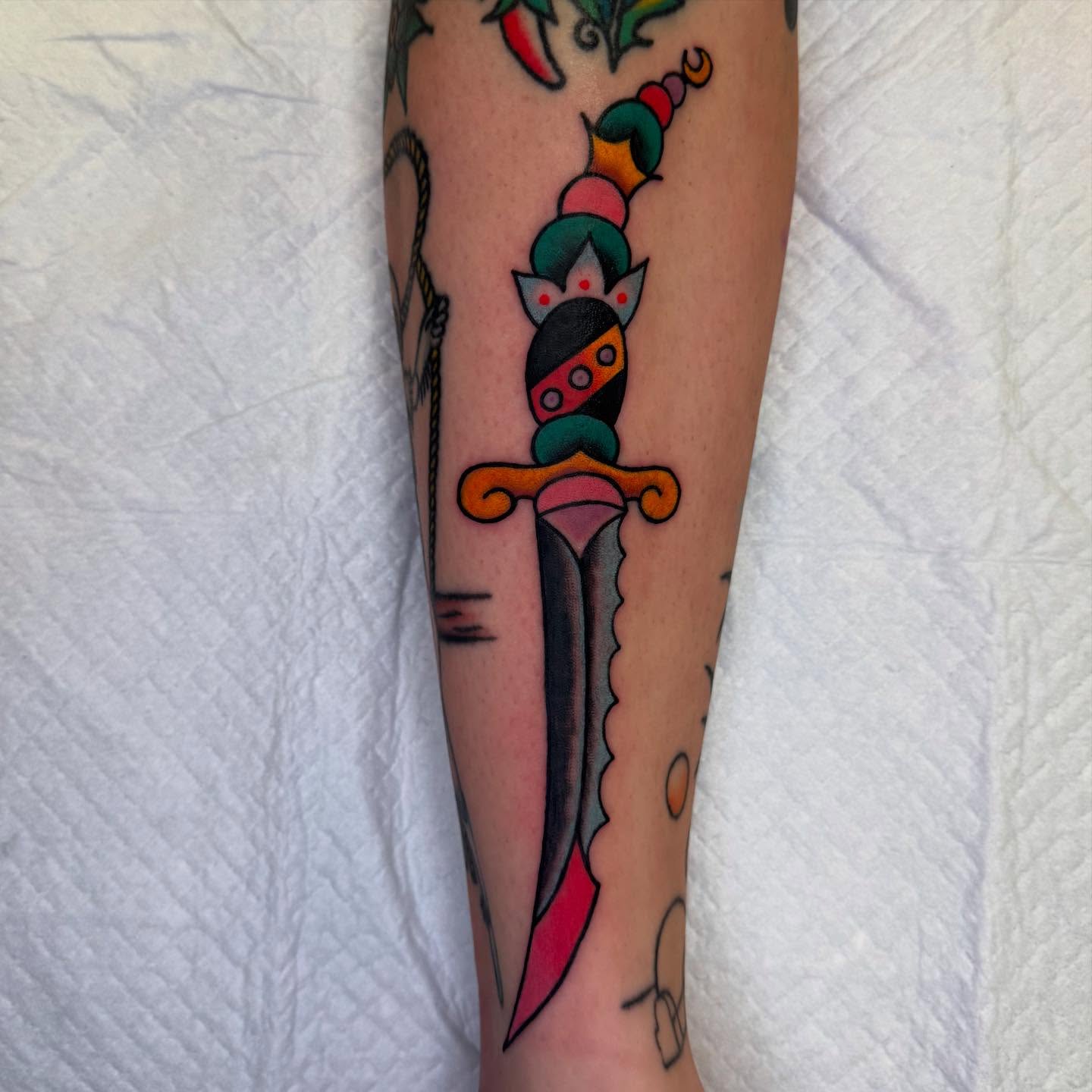 Knife American traditional tattoo on the forearm by Atom Aker