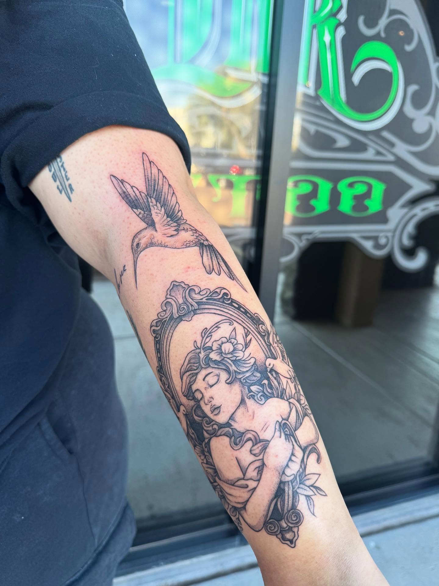 Woman with bird black and grey tattoo on the forearm by Jianna
