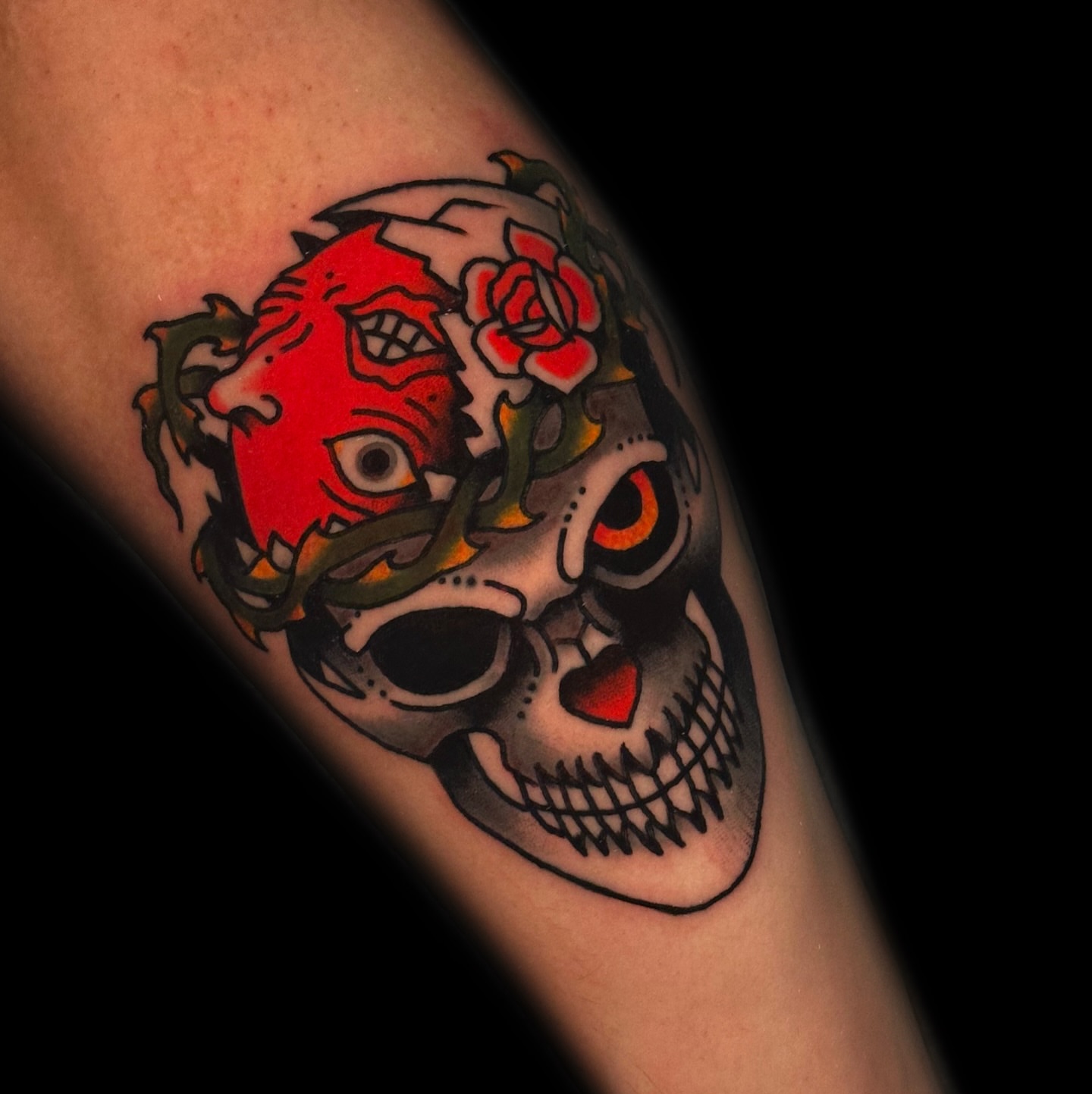 Skull and roses American traditional tattoo on the forearm by Danny Reis