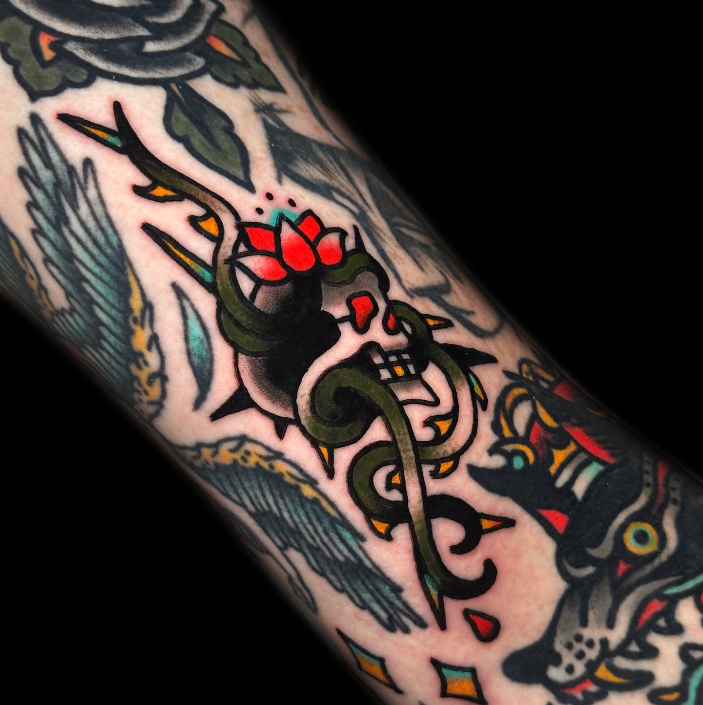 Lotus flower and dragon American traditional tattoo on the forearm by Danny Reis