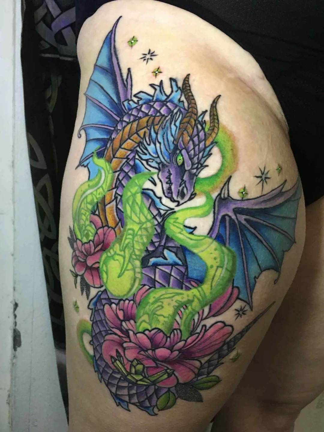 Dragon and snake geometric tattoo on the thigh by Rando Rad