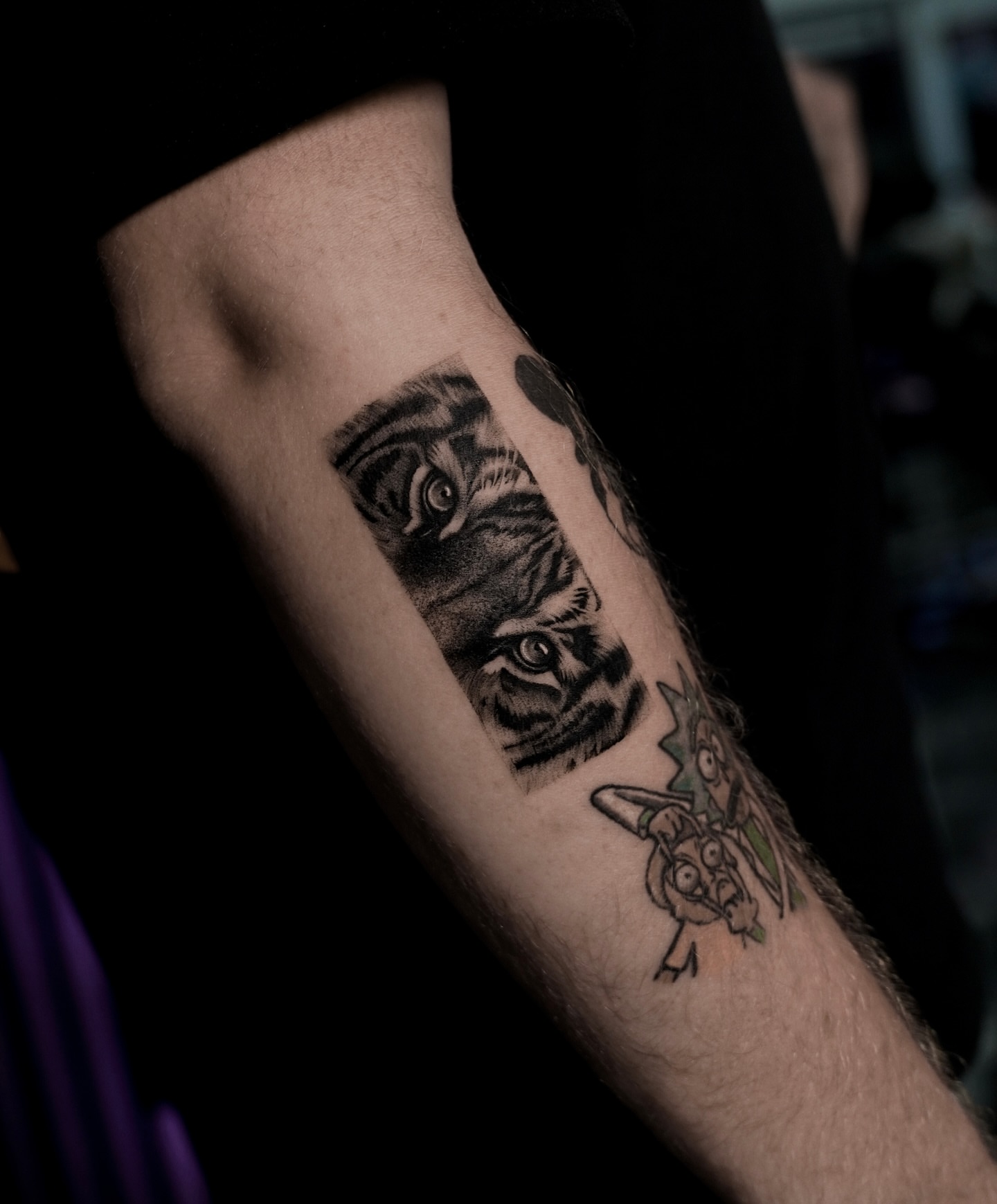 Tiger eyes black and grey tattoo on the forearm by Sophia Delfino