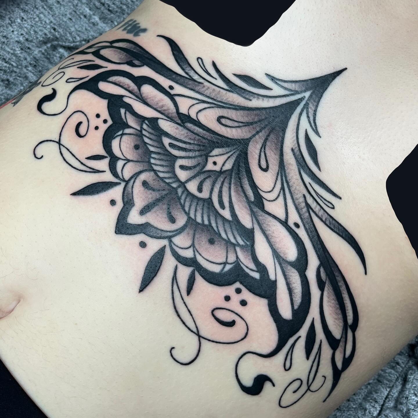 Floral black and grey tattoo on the ribs by Michigan Tattoo Artist - Nadia Garver, Clinton Township, Michigan