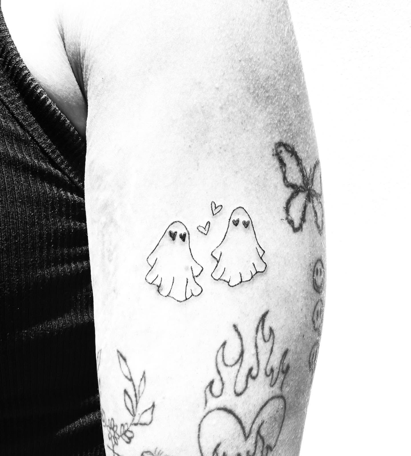 Ghosts black and grey tattoo on the forearm by Kylee Snow