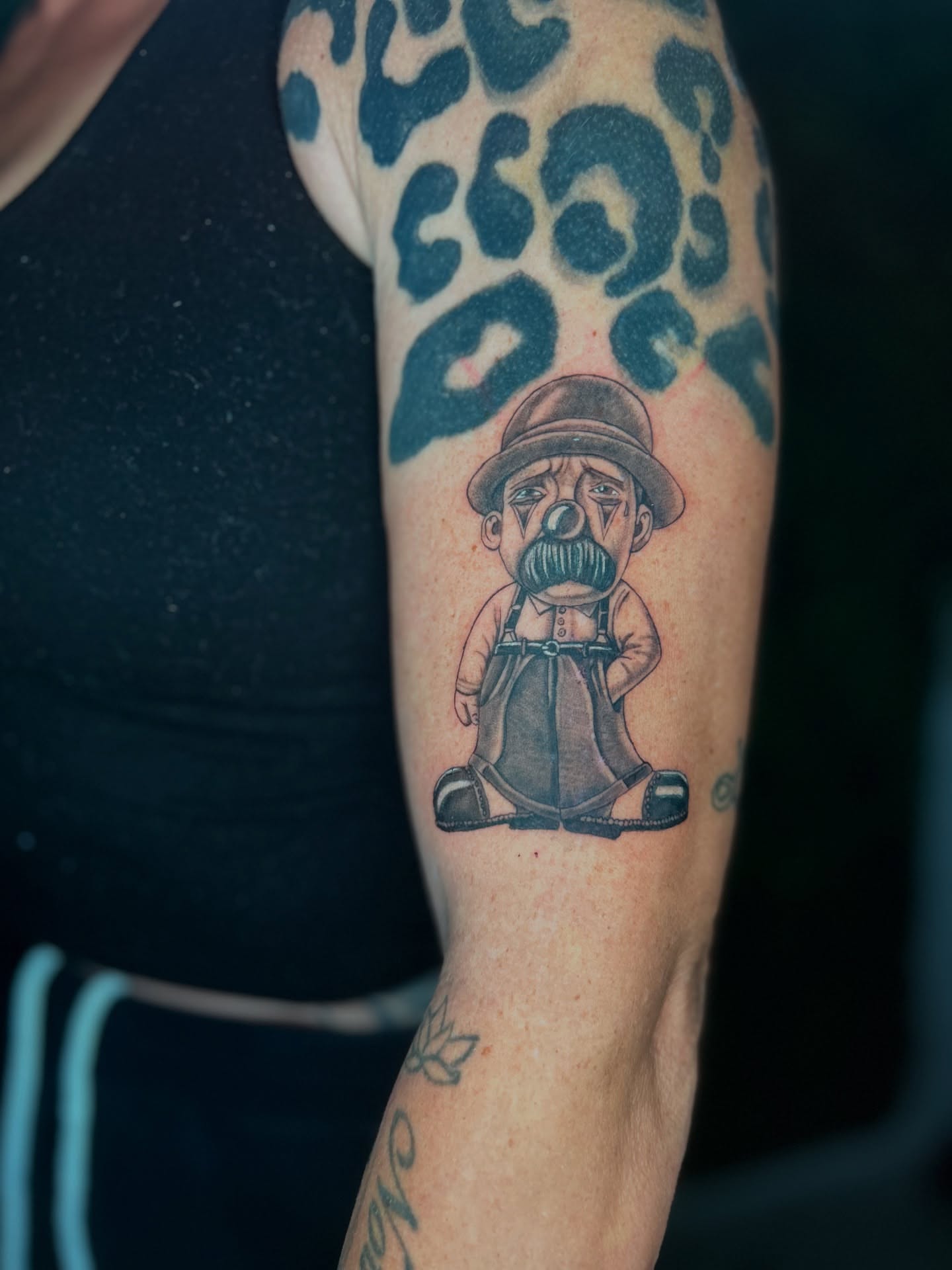 Clown black and grey tattoo on the forearm by Melissa C, Phoenix, Arizona