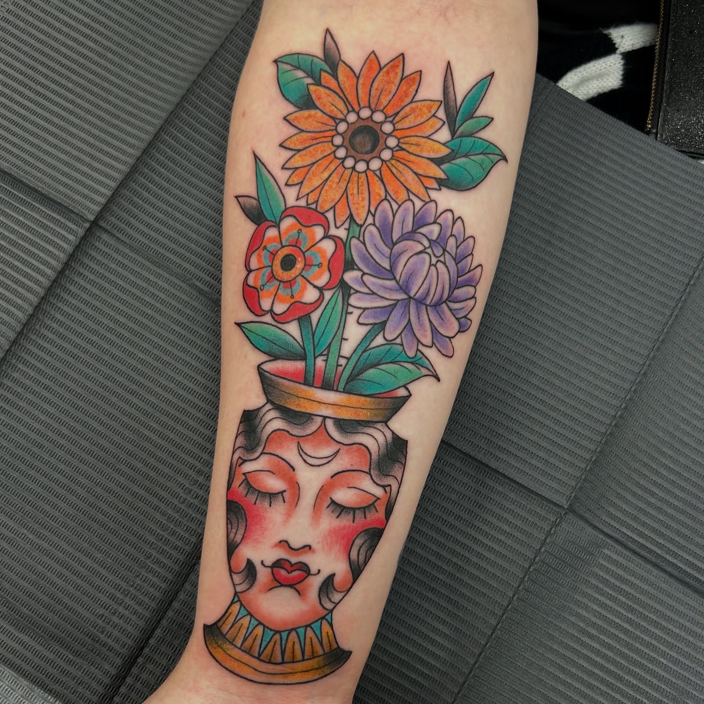 Flower pot with face American traditional tattoo on the forearm by Patricia Cunningham