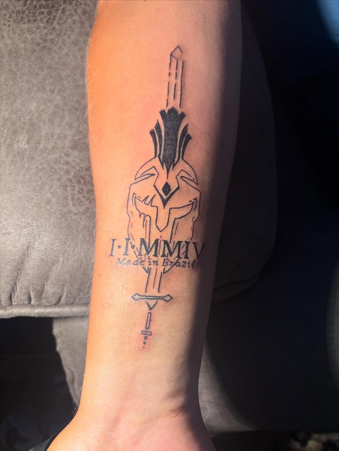 Helmeted warrior geometric tattoo on the forearm by sams tattoos