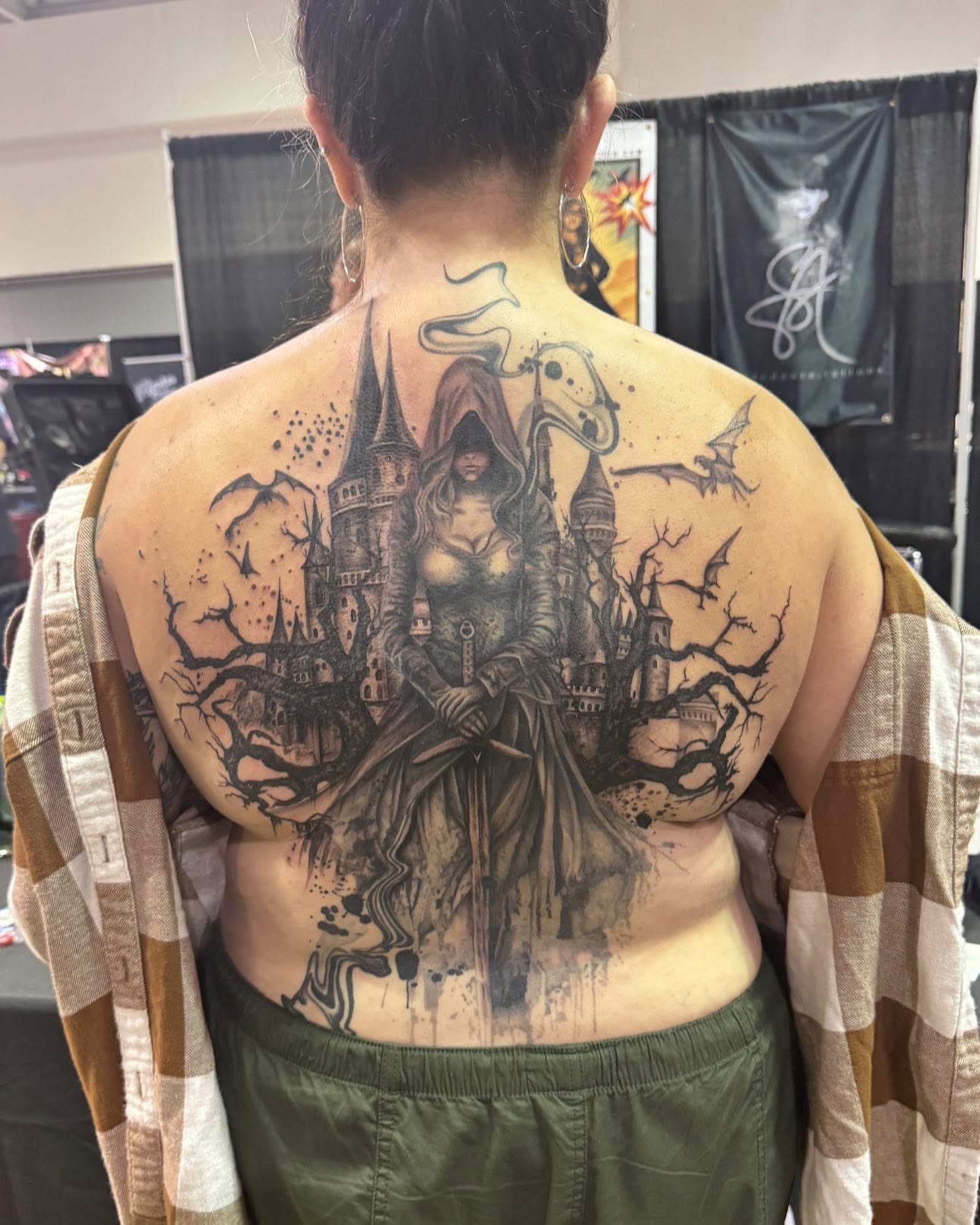 Castle and hooded figure dark realism tattoo on the back by Aura Noire