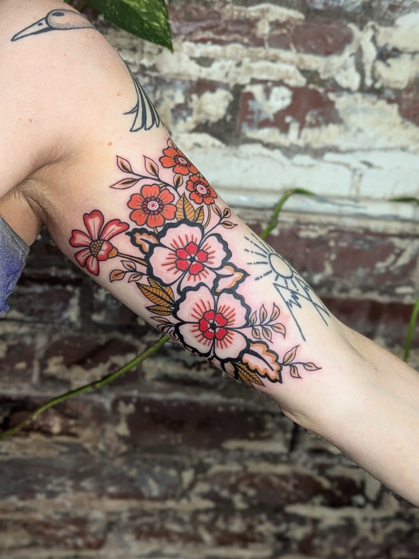 Floral bouquet new school tattoo on the forearm by Eli Studer