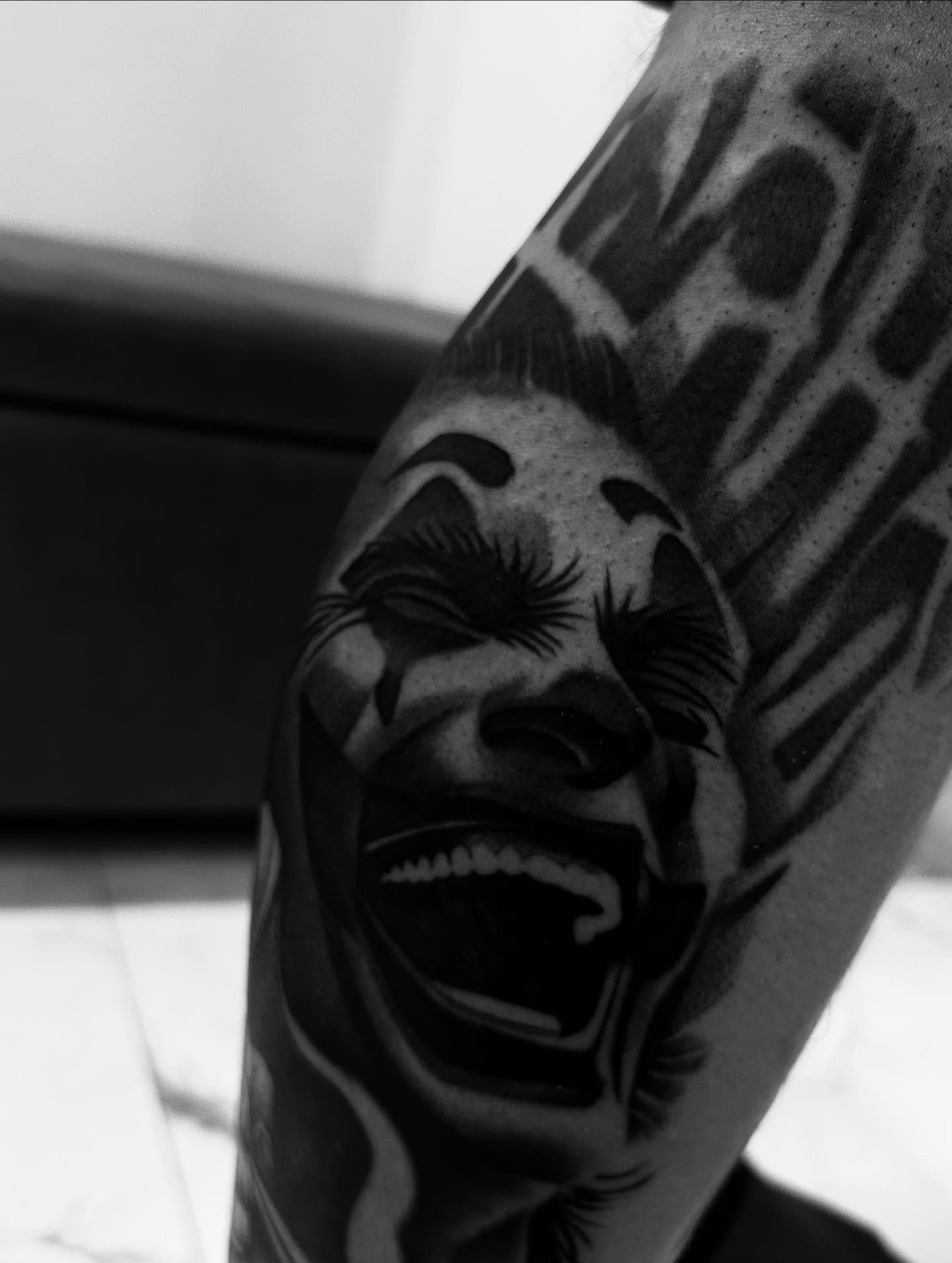 Laughing face realism tattoo on the forearm by Jaylen - Atlanta Tattoo Artist