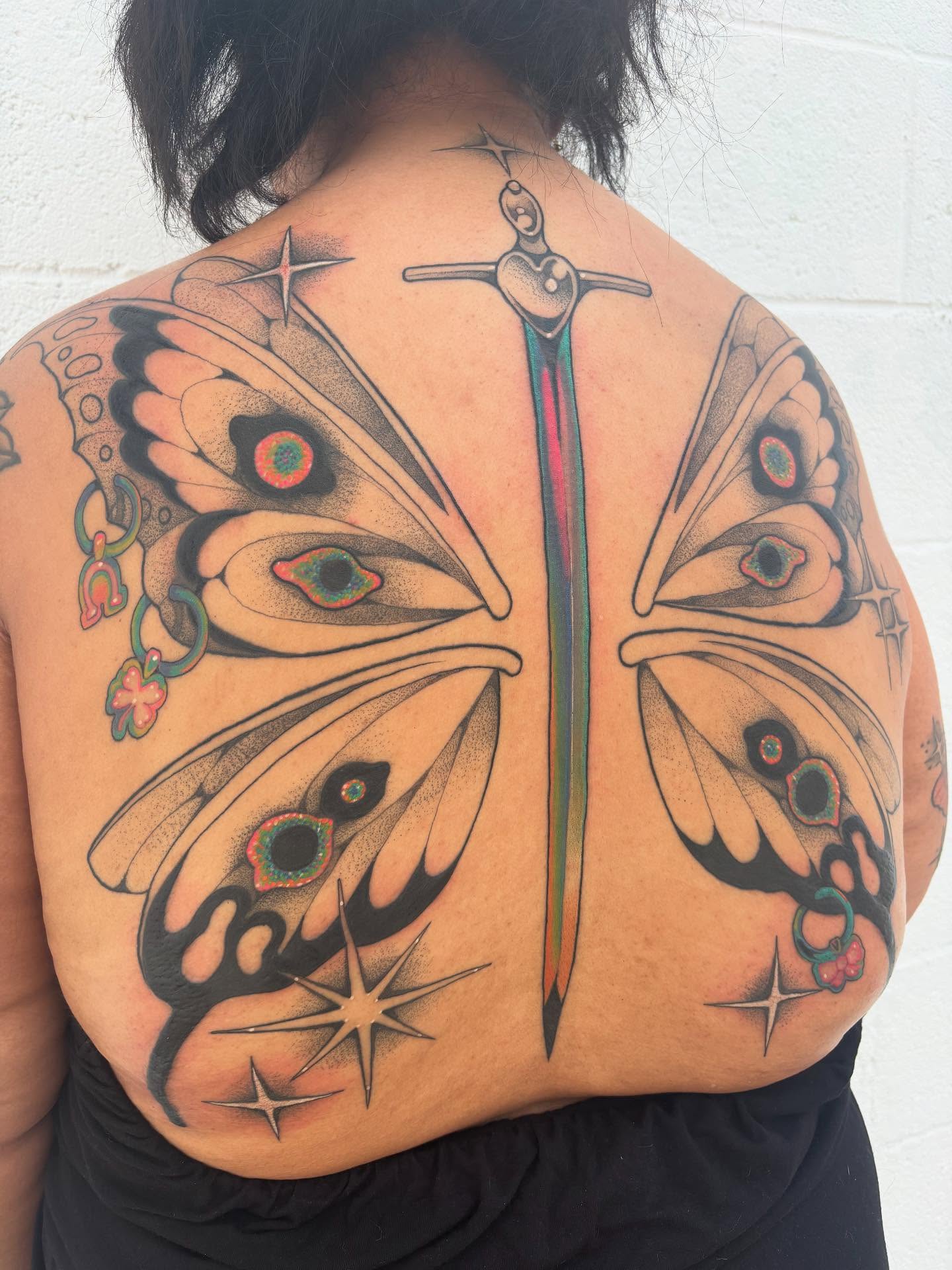 Butterfly dotwork tattoo on the back by Carly Zehring