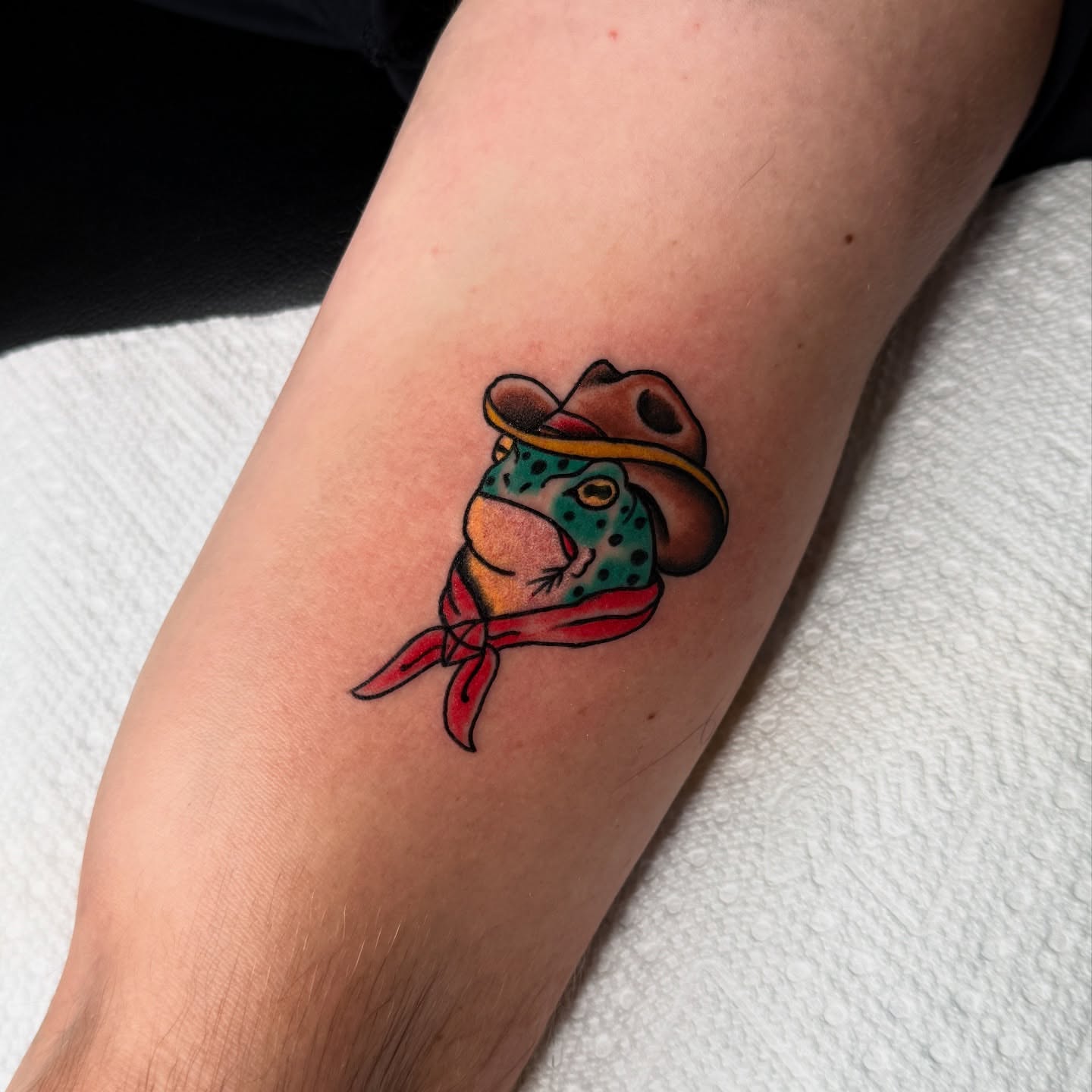 Frog wearing cowboy hat and bandana American traditional tattoo on the forearm by Andre Guerra