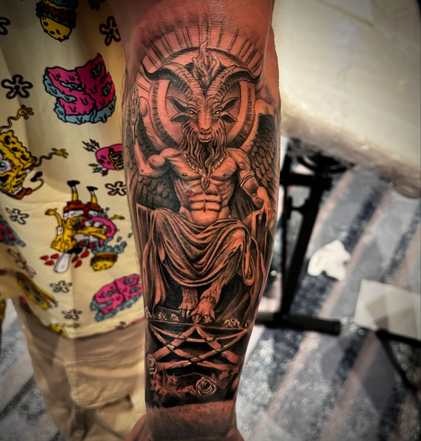 Goat-headed deity realism tattoo on the forearm by Mike Hudson
