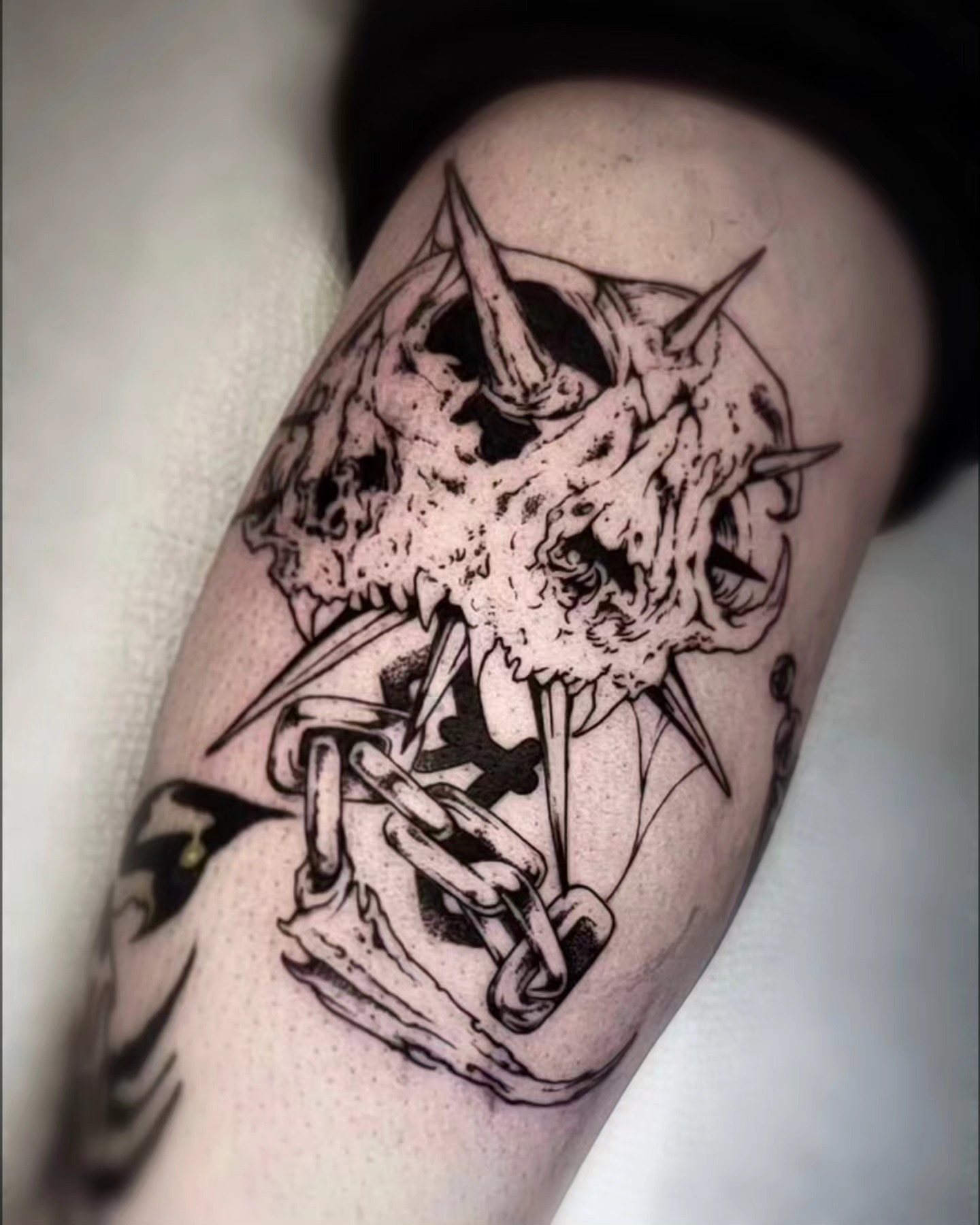 Skull and chain dark realism tattoo on the forearm by Luca