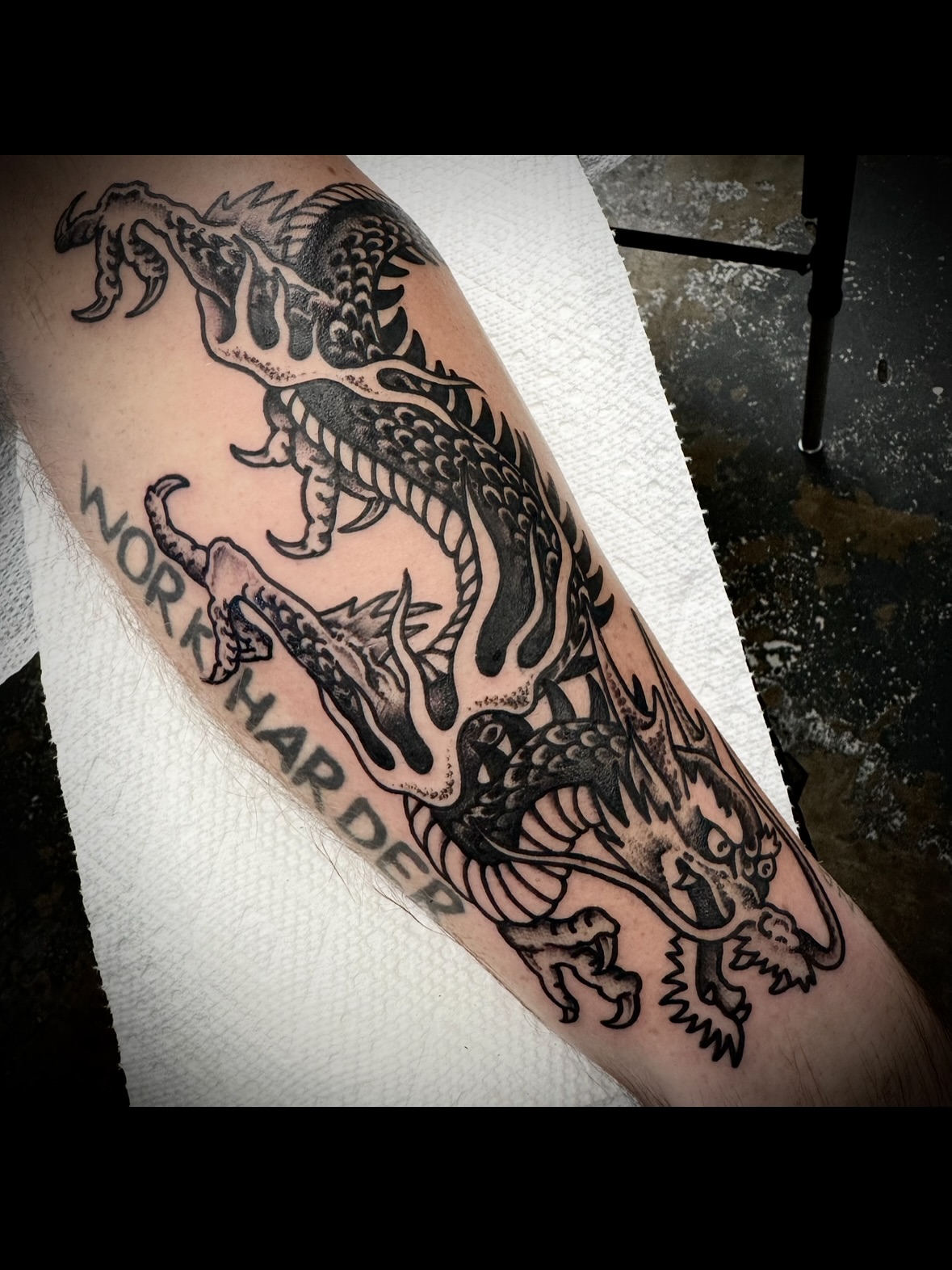 Dragon black and grey tattoo on the forearm by Kristen