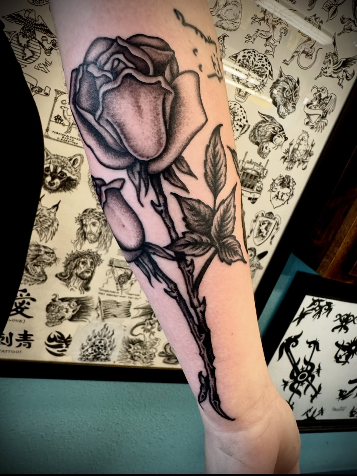 Rose black and grey tattoo on the forearm by Kristen