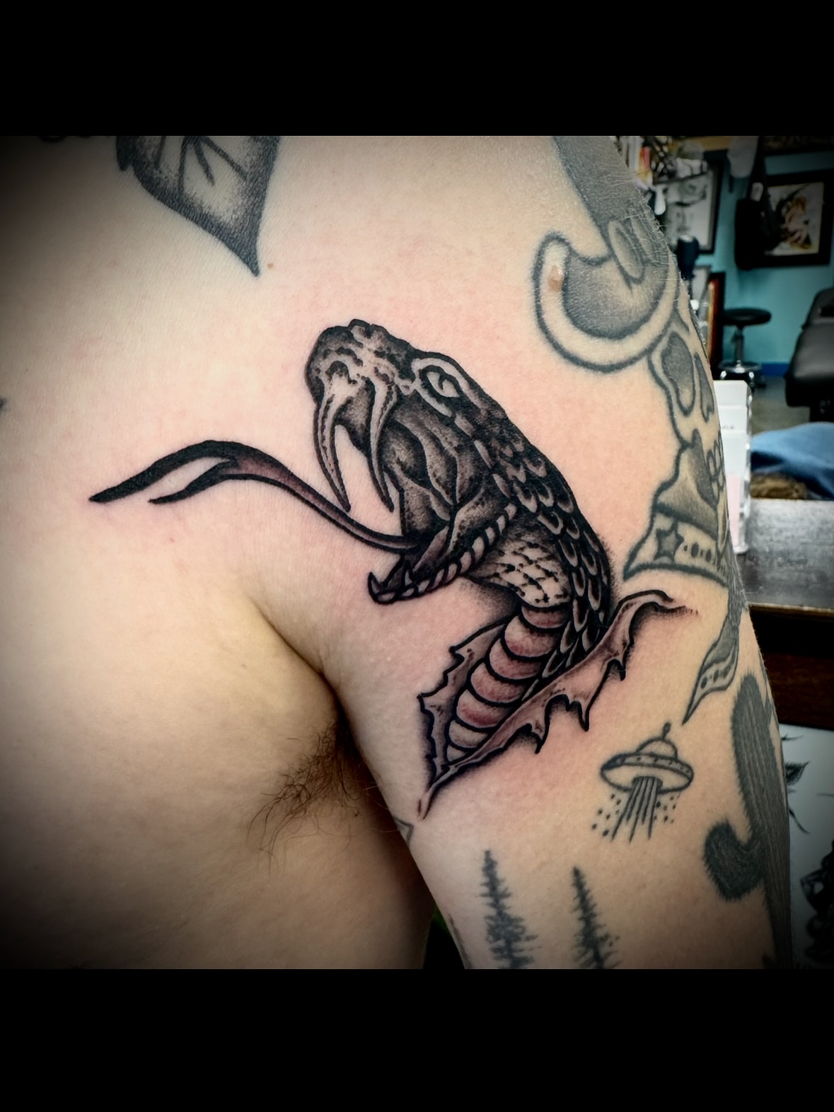 Snake American traditional tattoo on the shoulder by Kristen