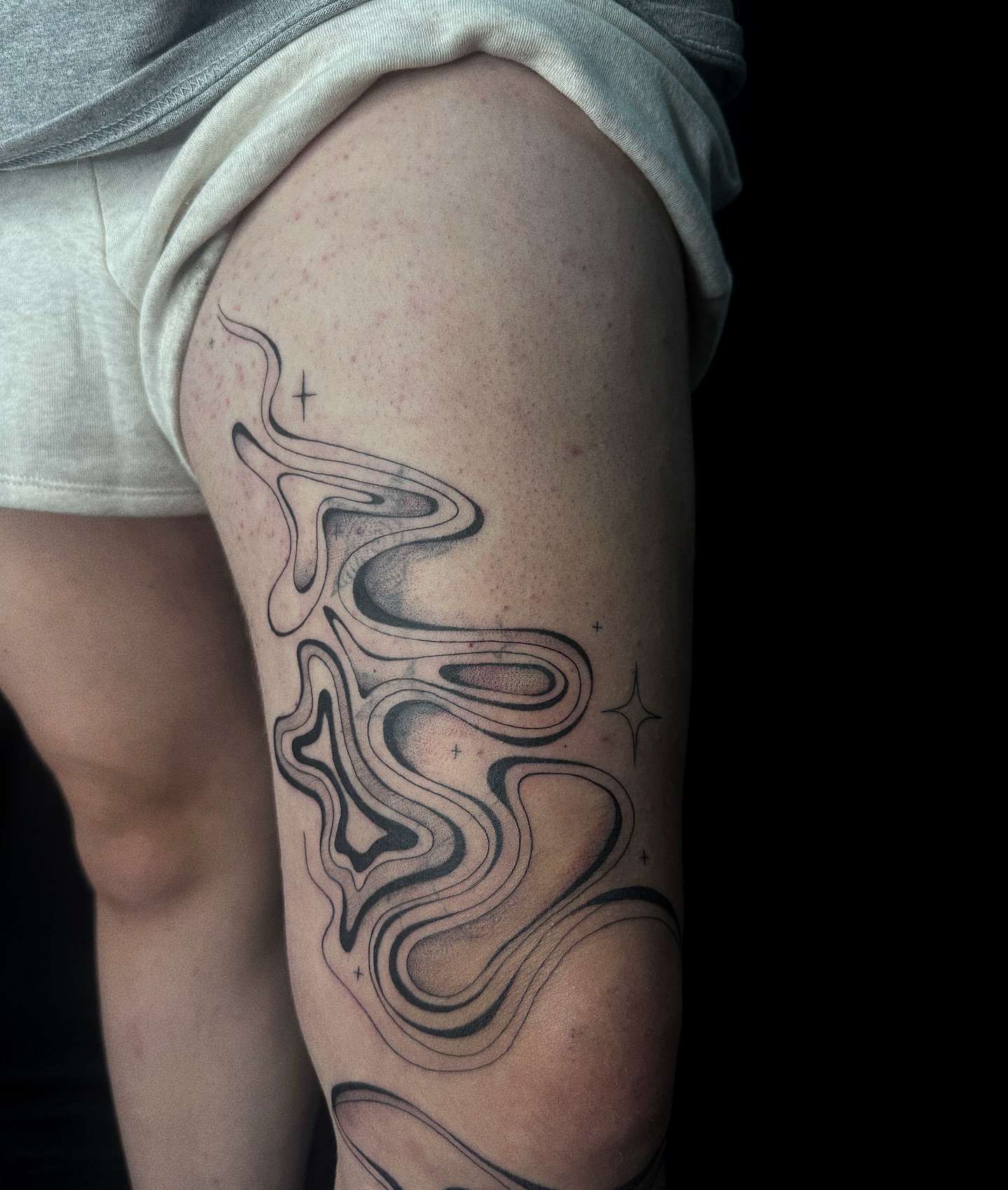 Abstract waves black and grey tattoo on the thigh by elena