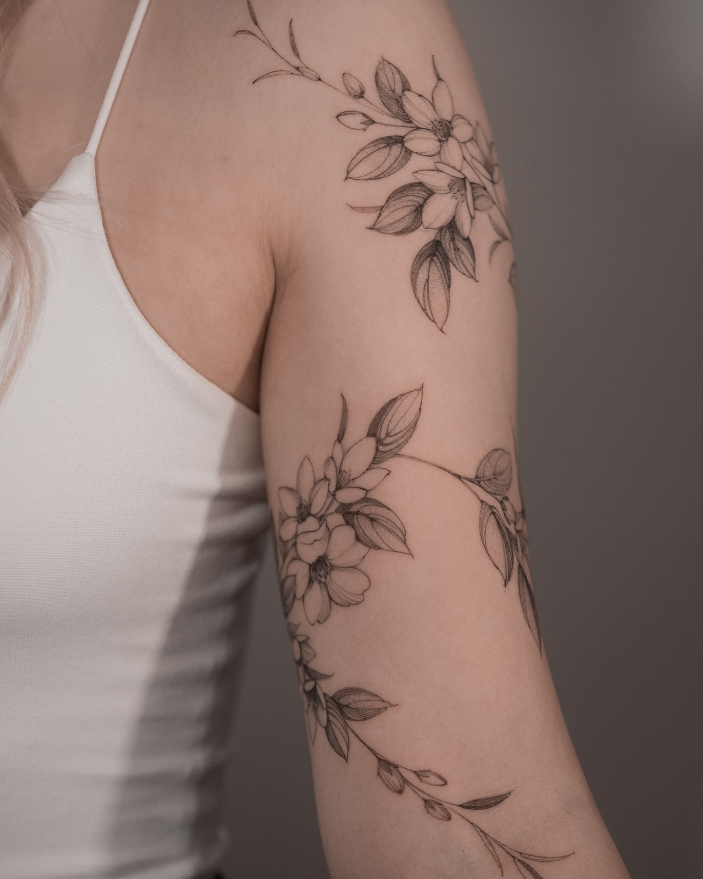 Floral arrangement black and grey tattoo on the forearm by Mary Shekh
