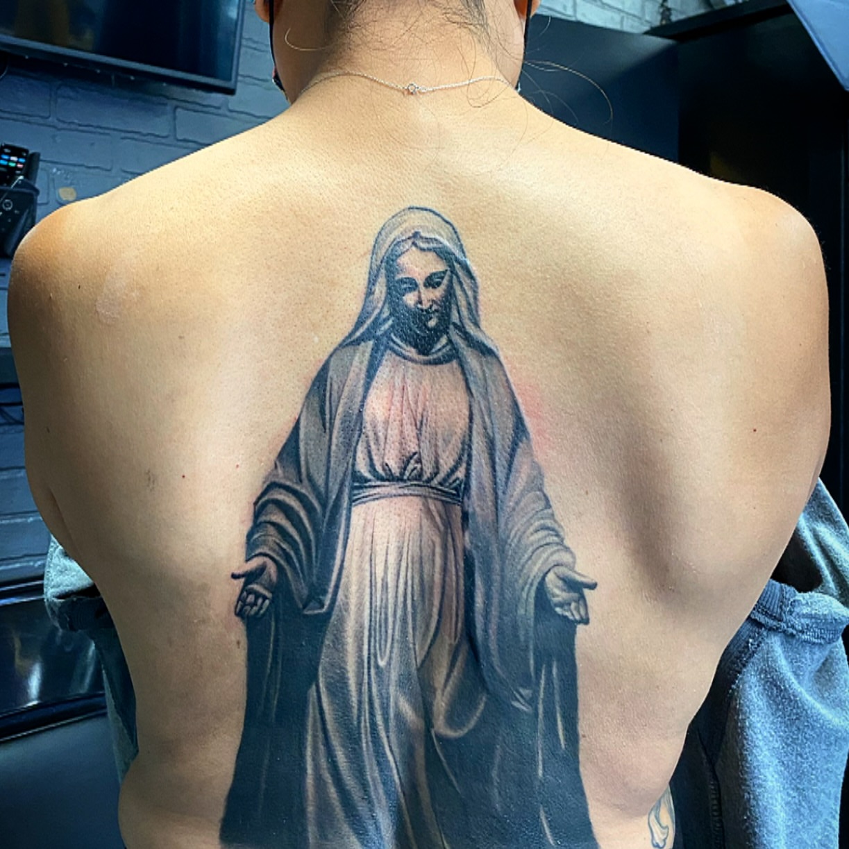 Religious figure realism tattoo on the back by El Pato, San Jose, California