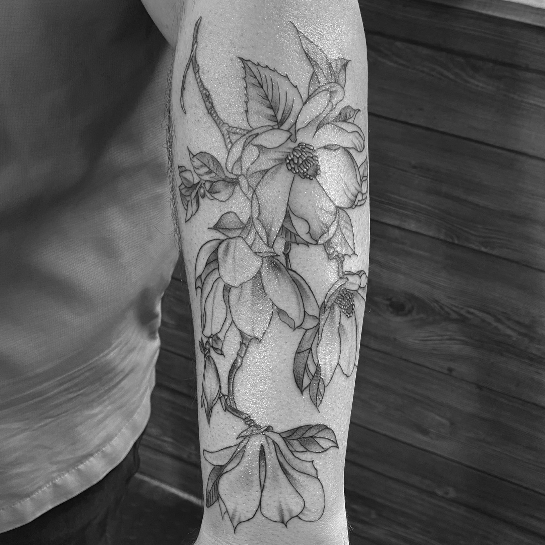 Dogwood flowers black and grey tattoo on the forearm by Spencer Jones Tattoos