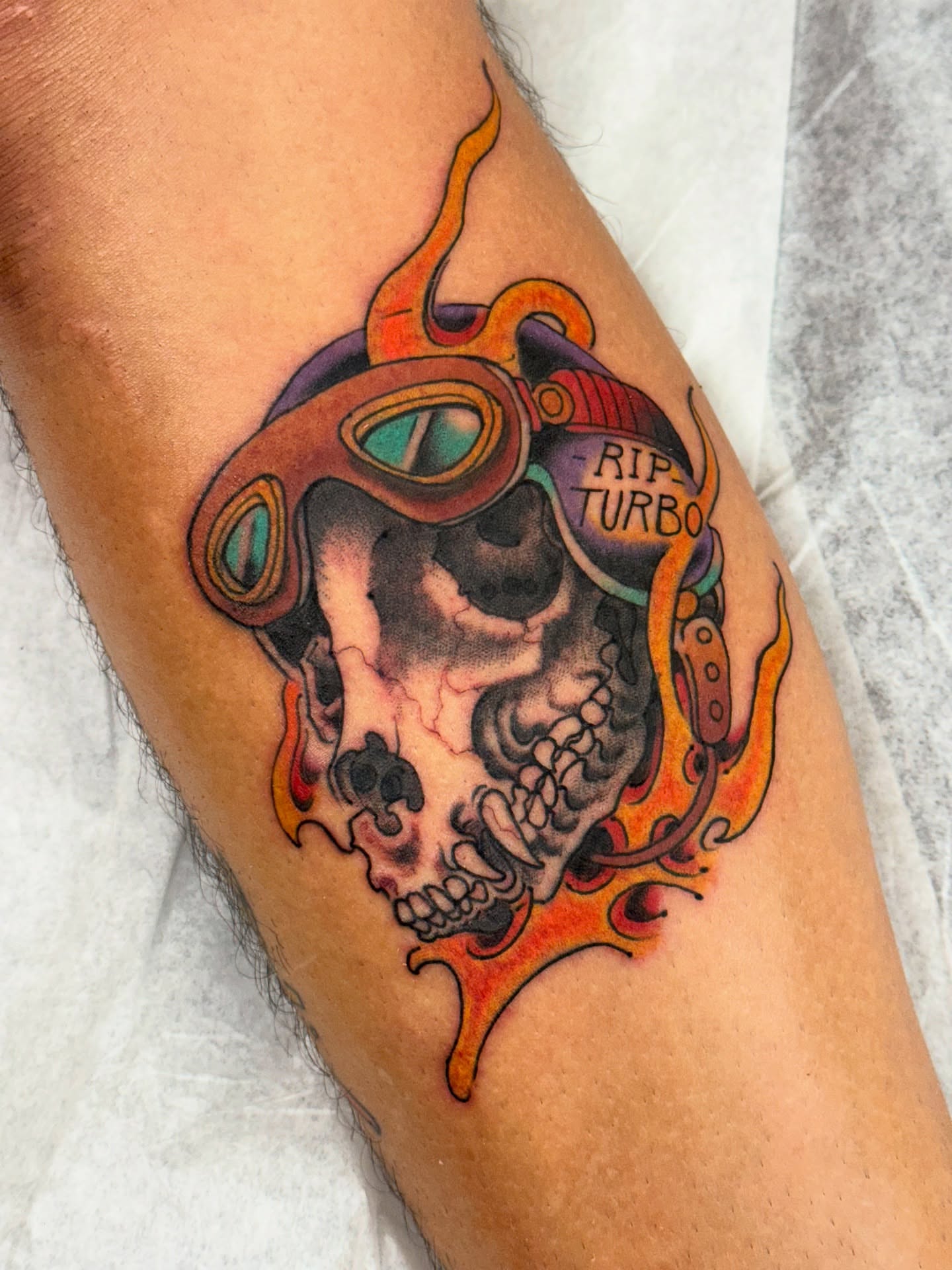 Skull with goggles American traditional tattoo on the thigh by Chris Orta