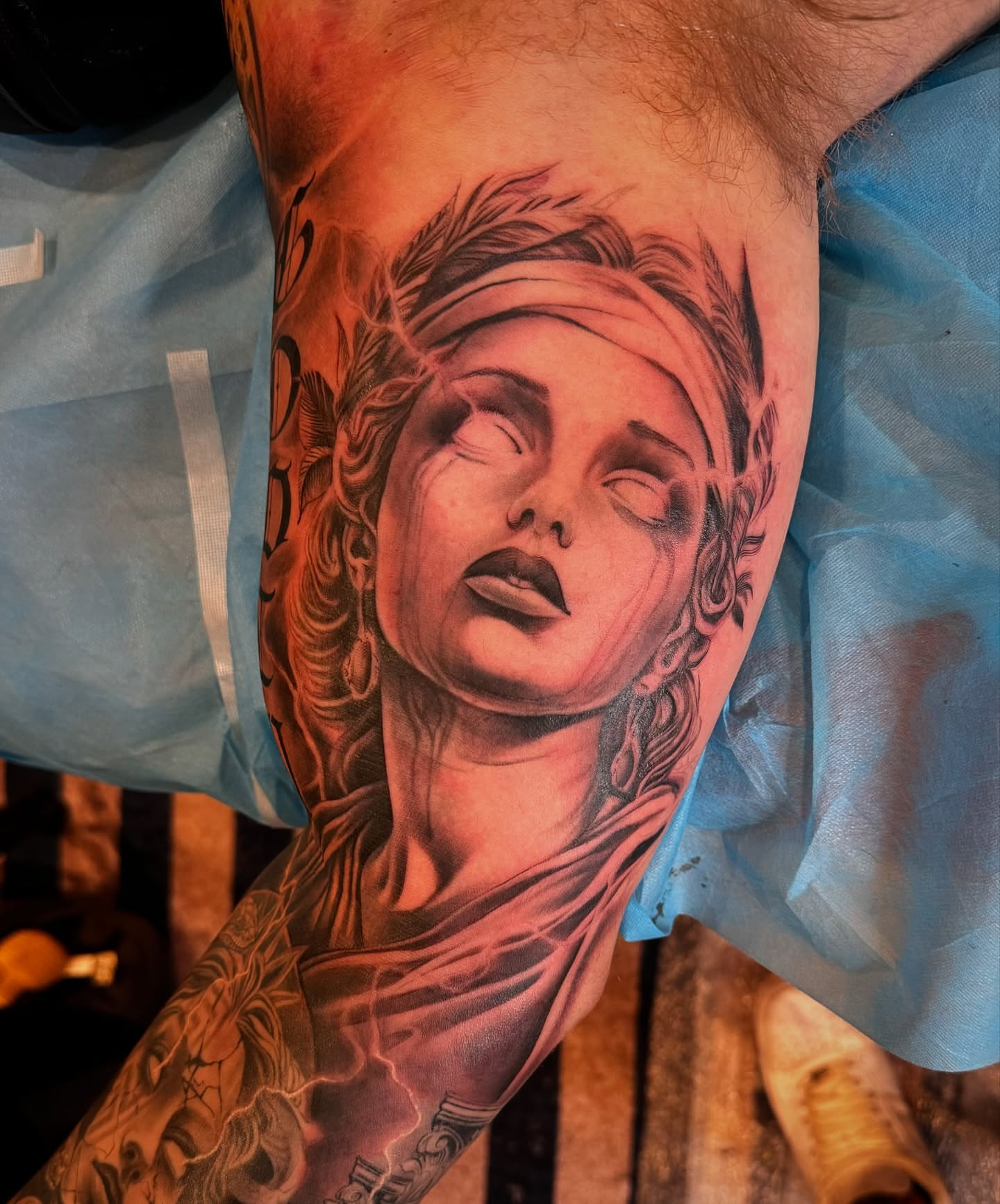 Woman's face realism tattoo on the forearm by Mike Hudson